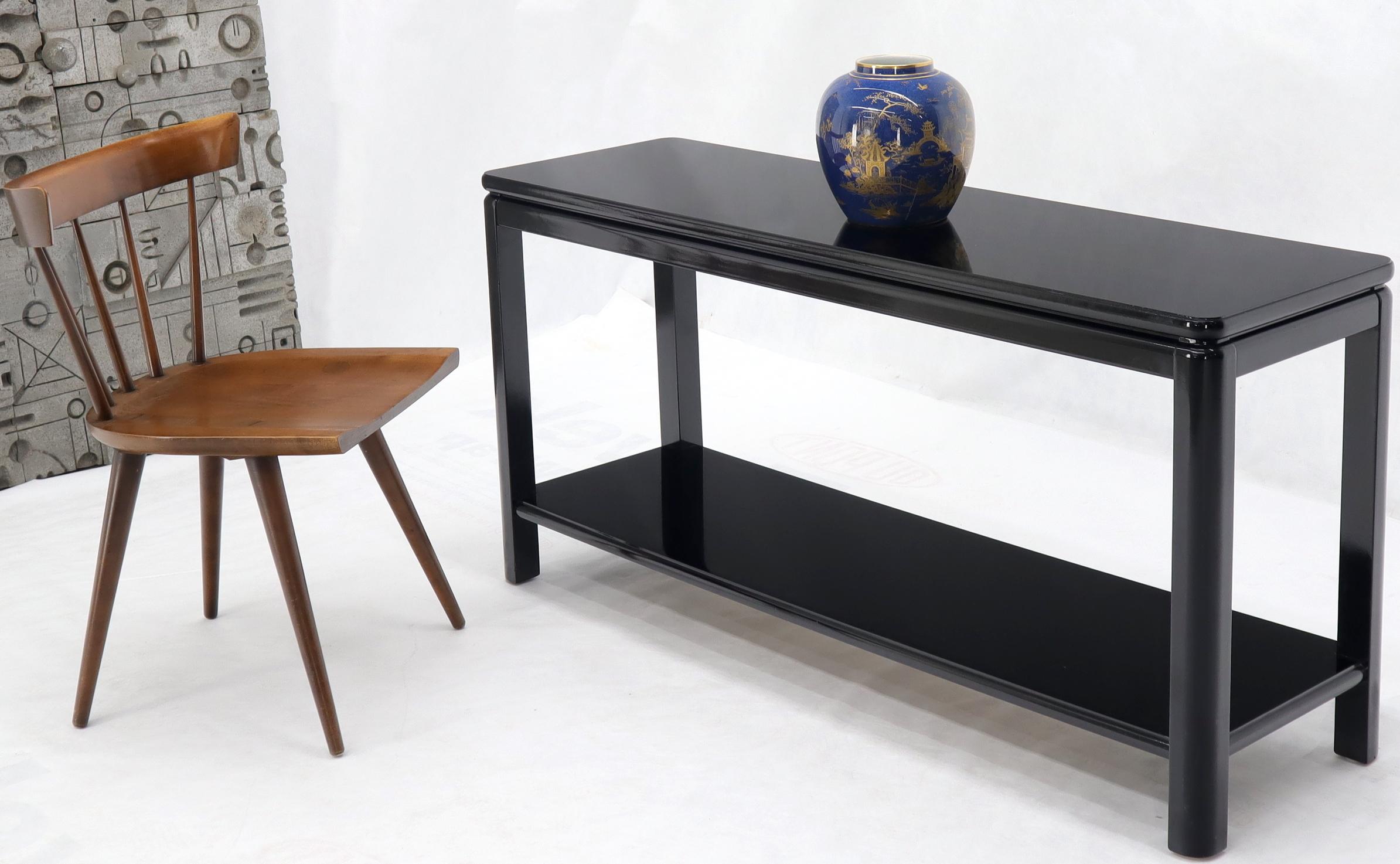 Mid-Century Modern black lacquer two-tier console table.