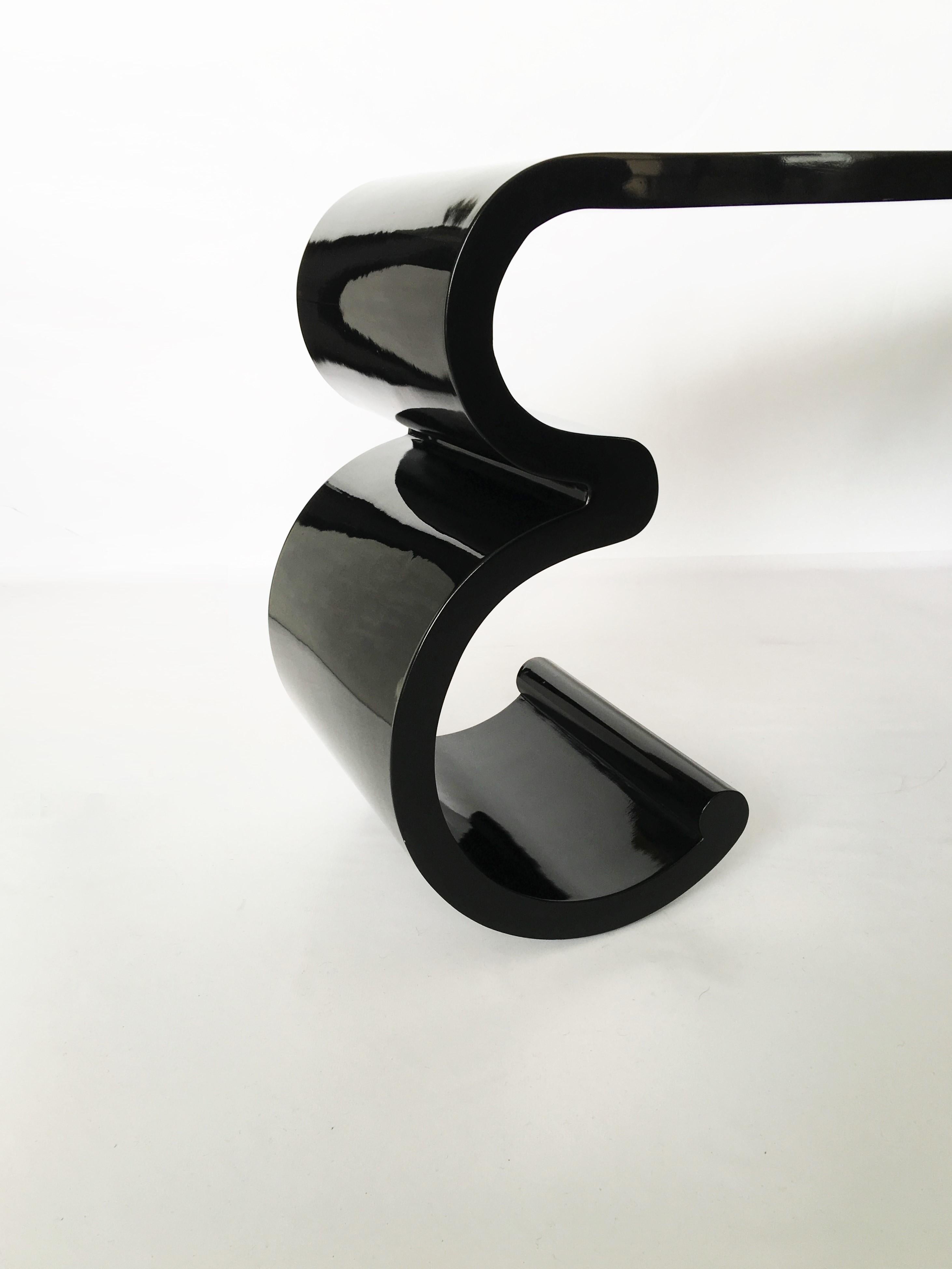 Sensational and dramatic console table with geometric profile in the manner of Karl Springer features a glossy black lacquer finish. Outstanding piece with great presence and exceptional design.
