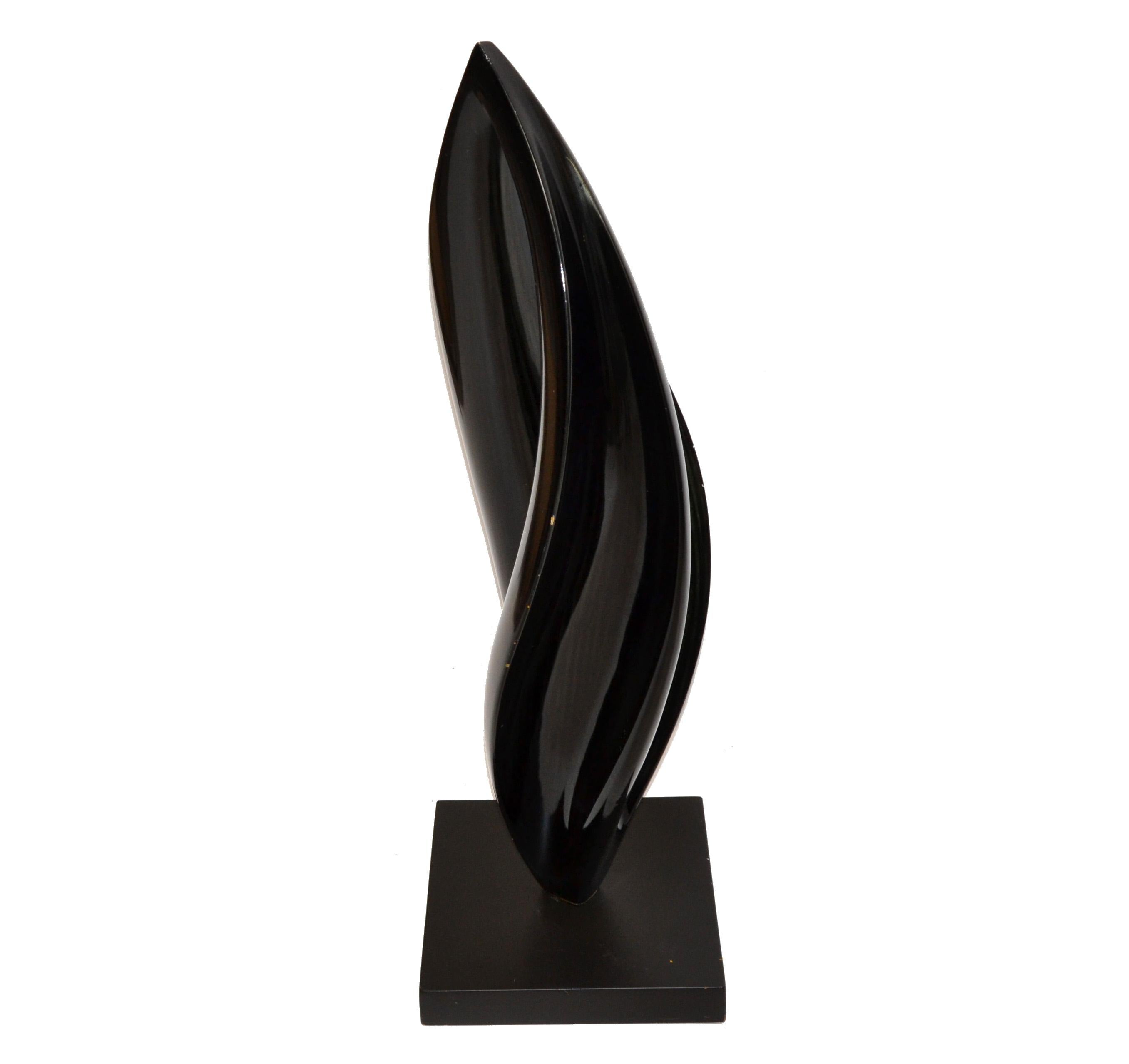Large Mid-Century Modern organic shaped wood sculpture in lacquered black finish.
The fine art sculpture is made out of one piece of wood.
Mounted on a square base and looks stunning in his floating design.