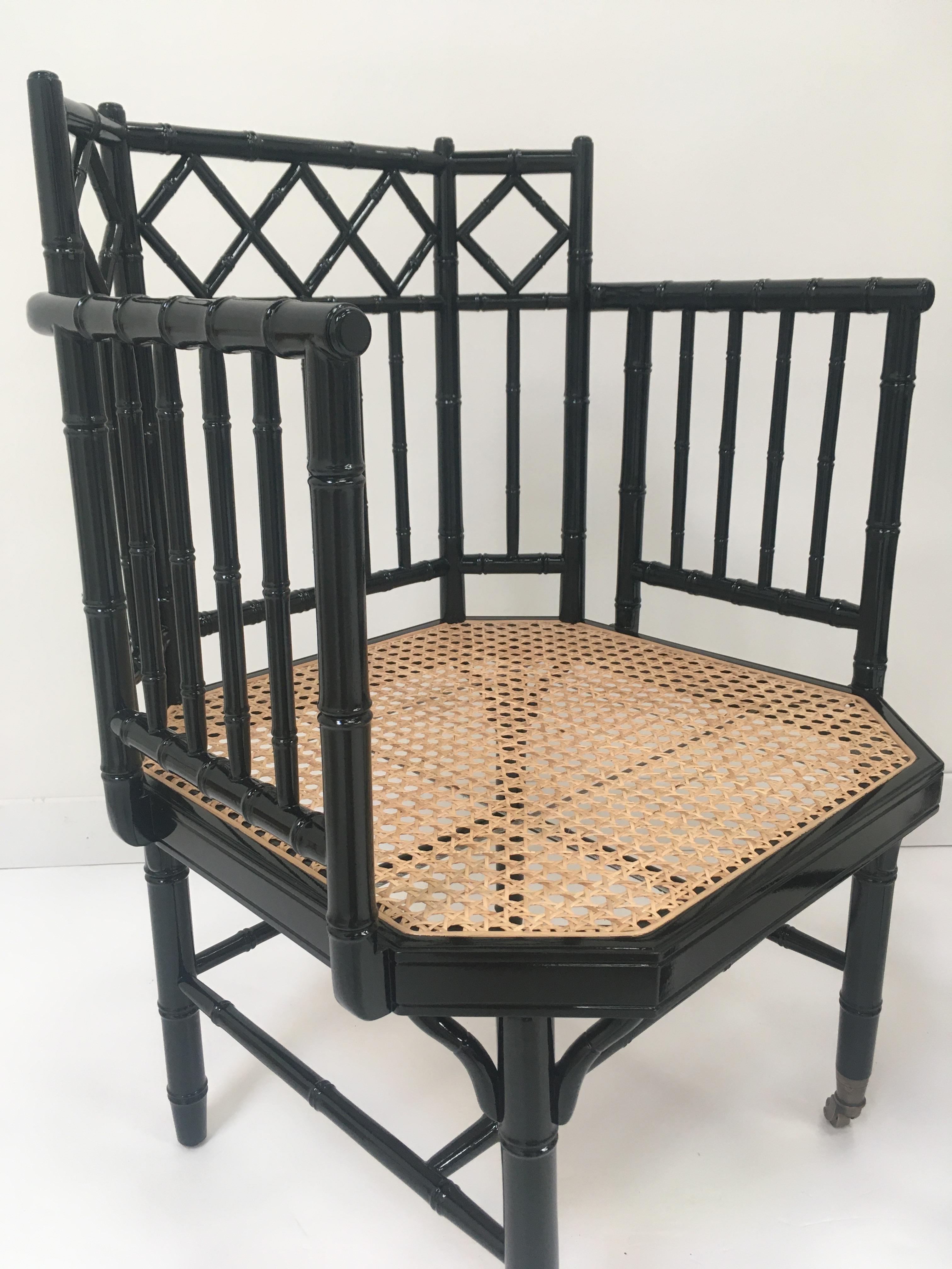 Art Deco design black lacquer wooden structure bamboo effect sculpted brass wheels finish adorned with woven cane seat and green fabric.