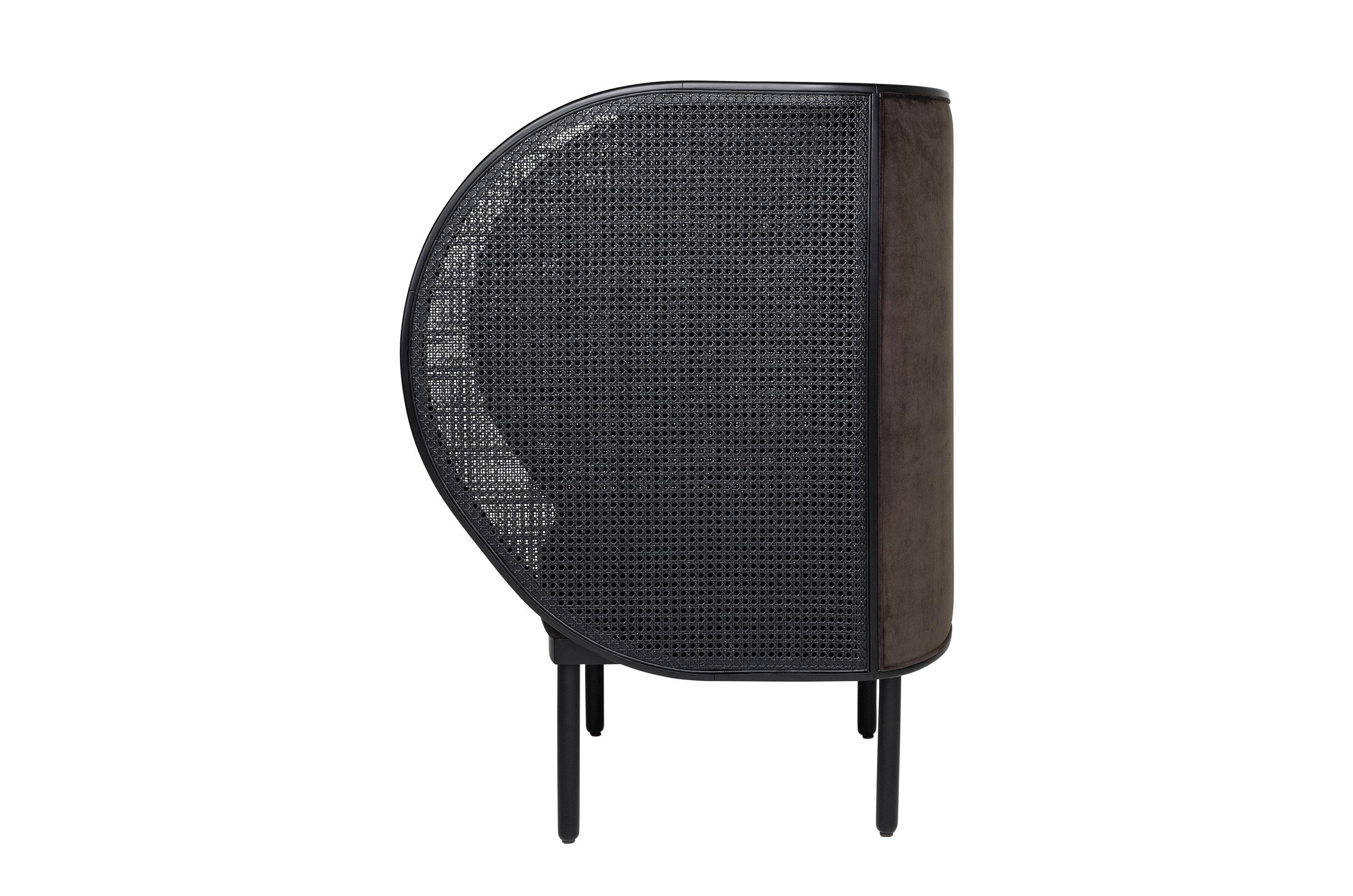 Hideout lounge armchair composed of black lacquered woven wicker cane and black wooden frame with velvet back and seat.