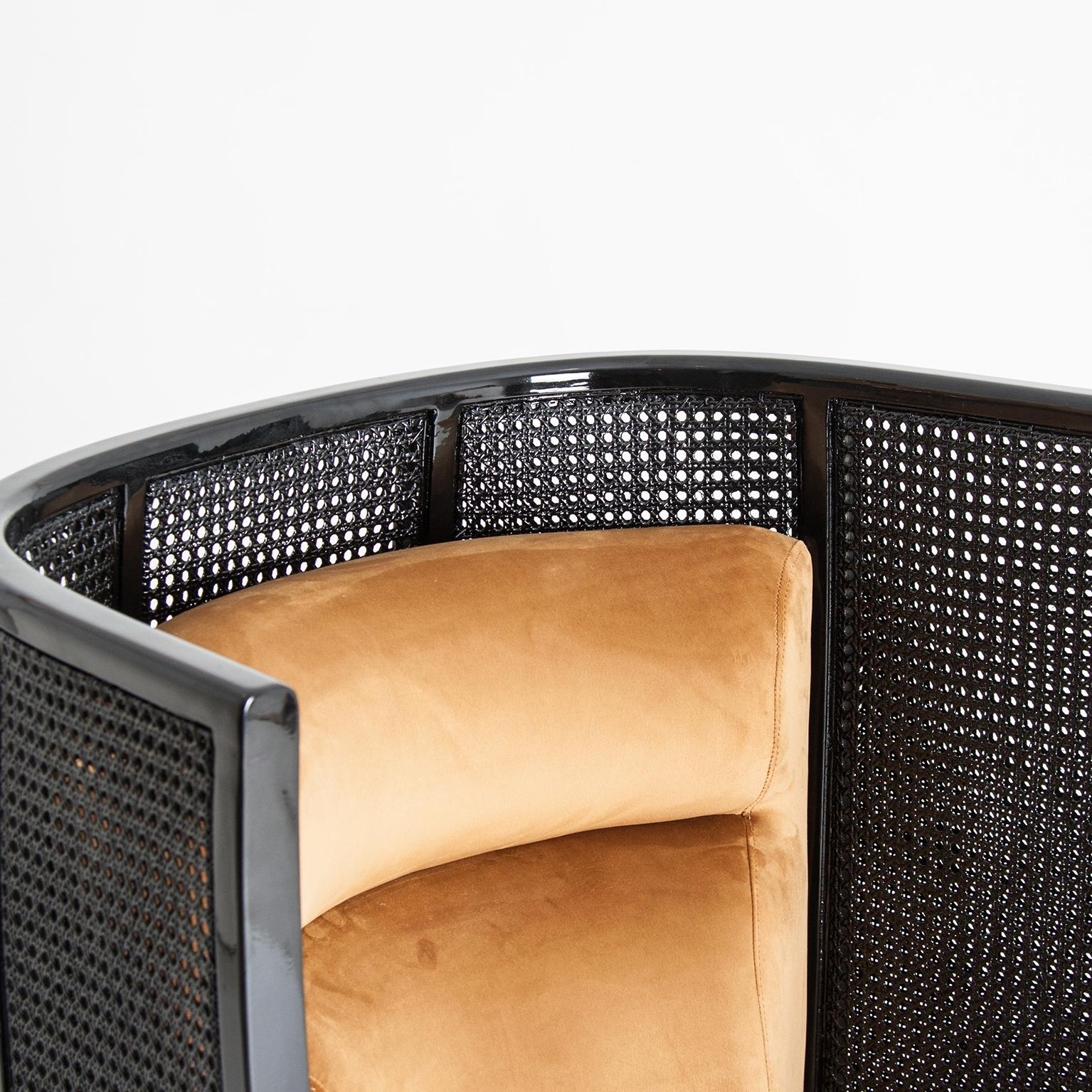 Black lacquered woven wicker cane with gold feet, velvet lounge armchair.