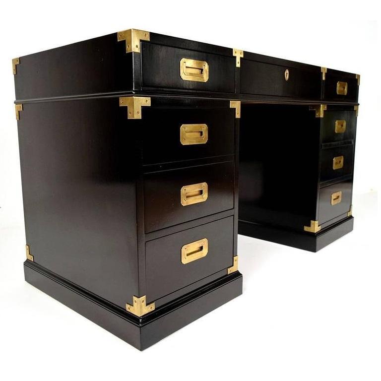 Fine quality desk. It includes seven drawers, a central drawer with a pencil/pen ledge inside between the pedestals and two small drawers. One filing drawer on each side. The brass military handles are stunning and embedded into the drawers as well