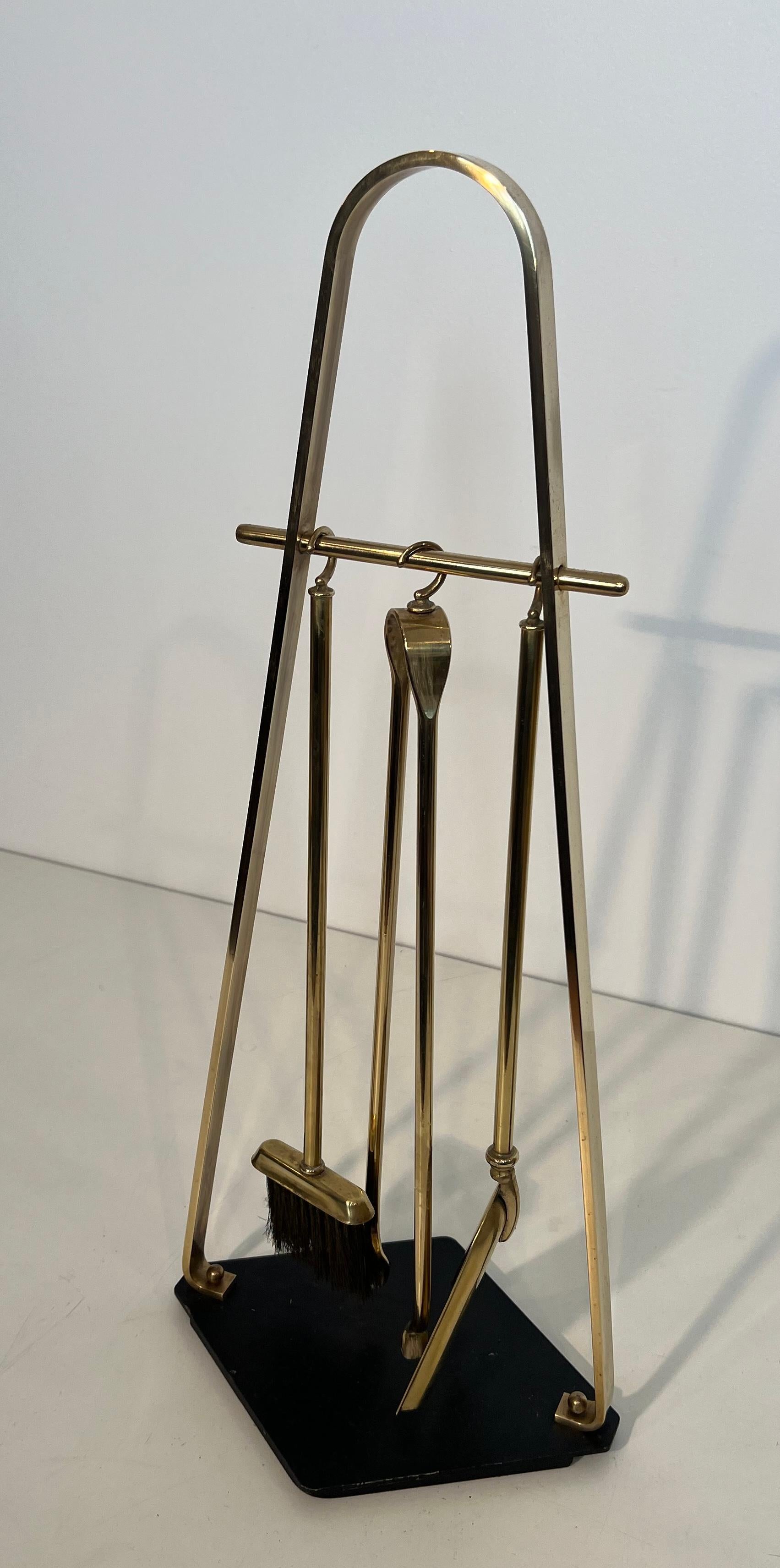 This very nice design fireplace tools set is made of black lacquered and brass. This is a French work. Circa 1970