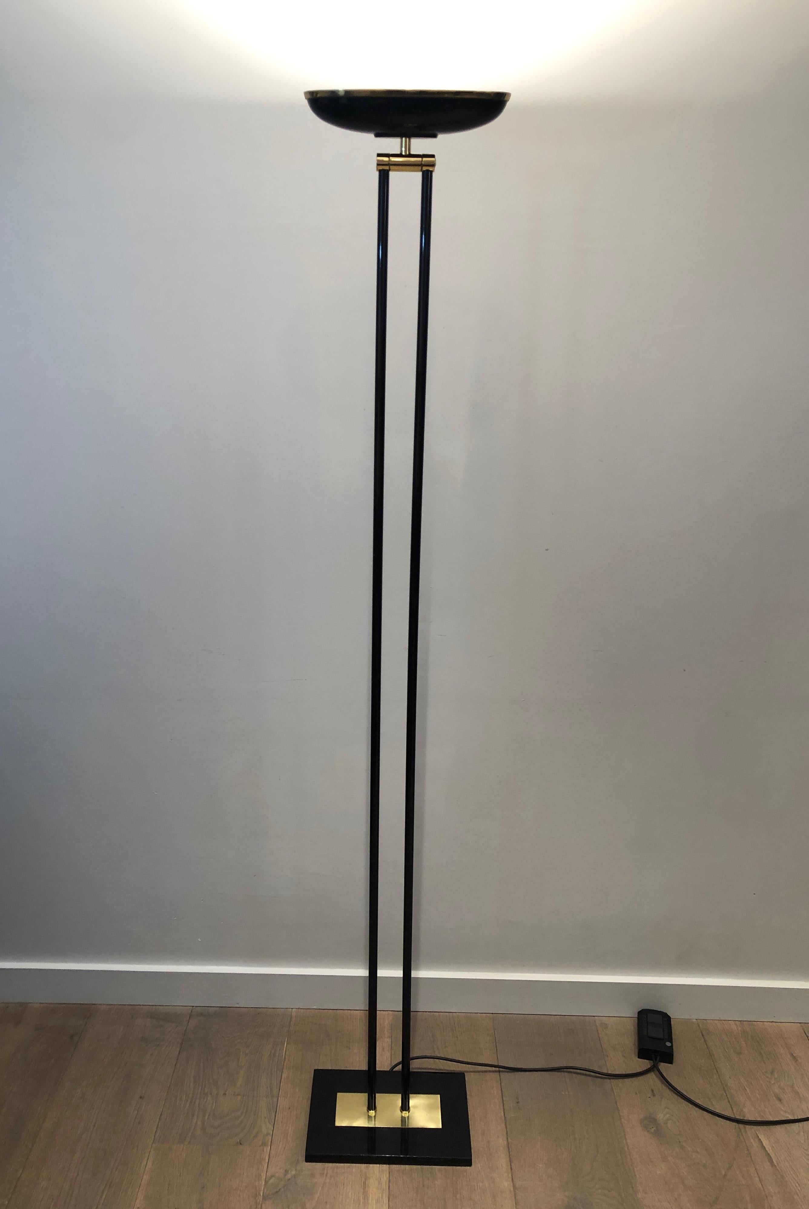 This halogen floor lamp is made of black lacquered and brass. This is a French work. Circa 1970.