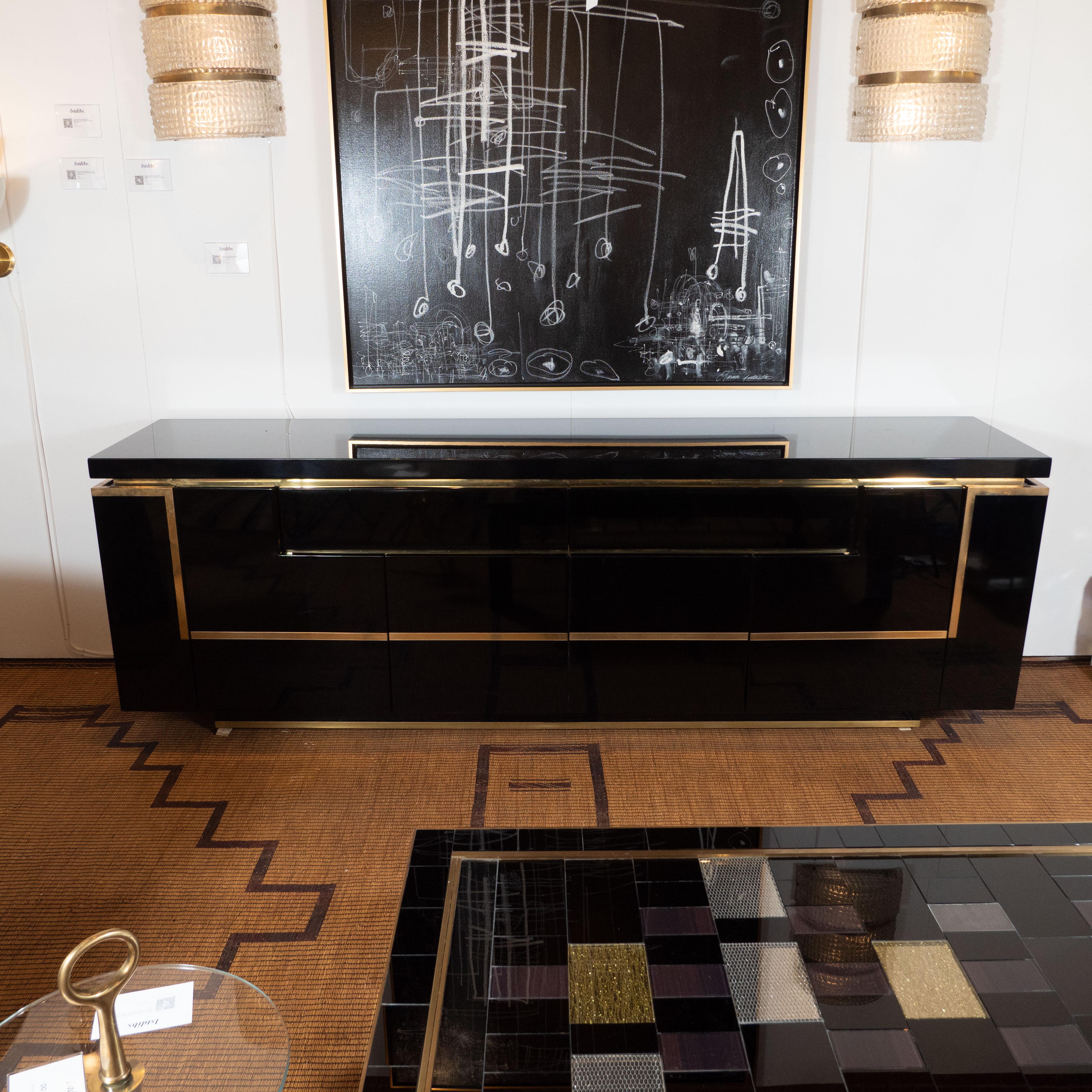 This black lacquered and brass sideboard or credenza was designed and handcrafted by Jean Claude Mahey in France, circa 1970. It is a fabulous and unique piece not only for its clean design and craftsmanship but also for the condition it is in. Made