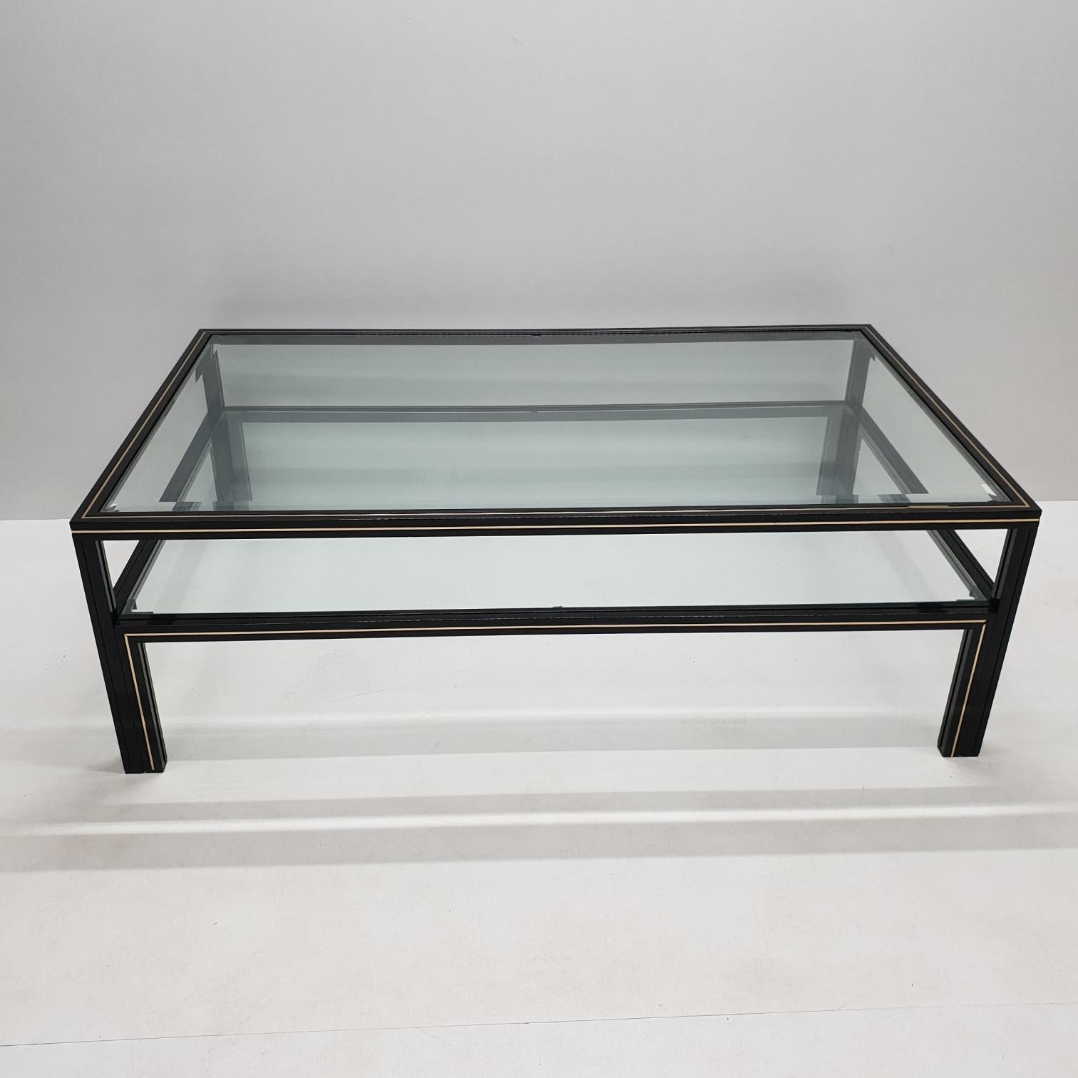 Black lacquer and brass two-tier coffee table by Pierre Vandel for Pierre Vandel (marked), 1970s.
With faceted glass.
French design.

Very good vintage condition, no defects, but it may show slight traces of use.
