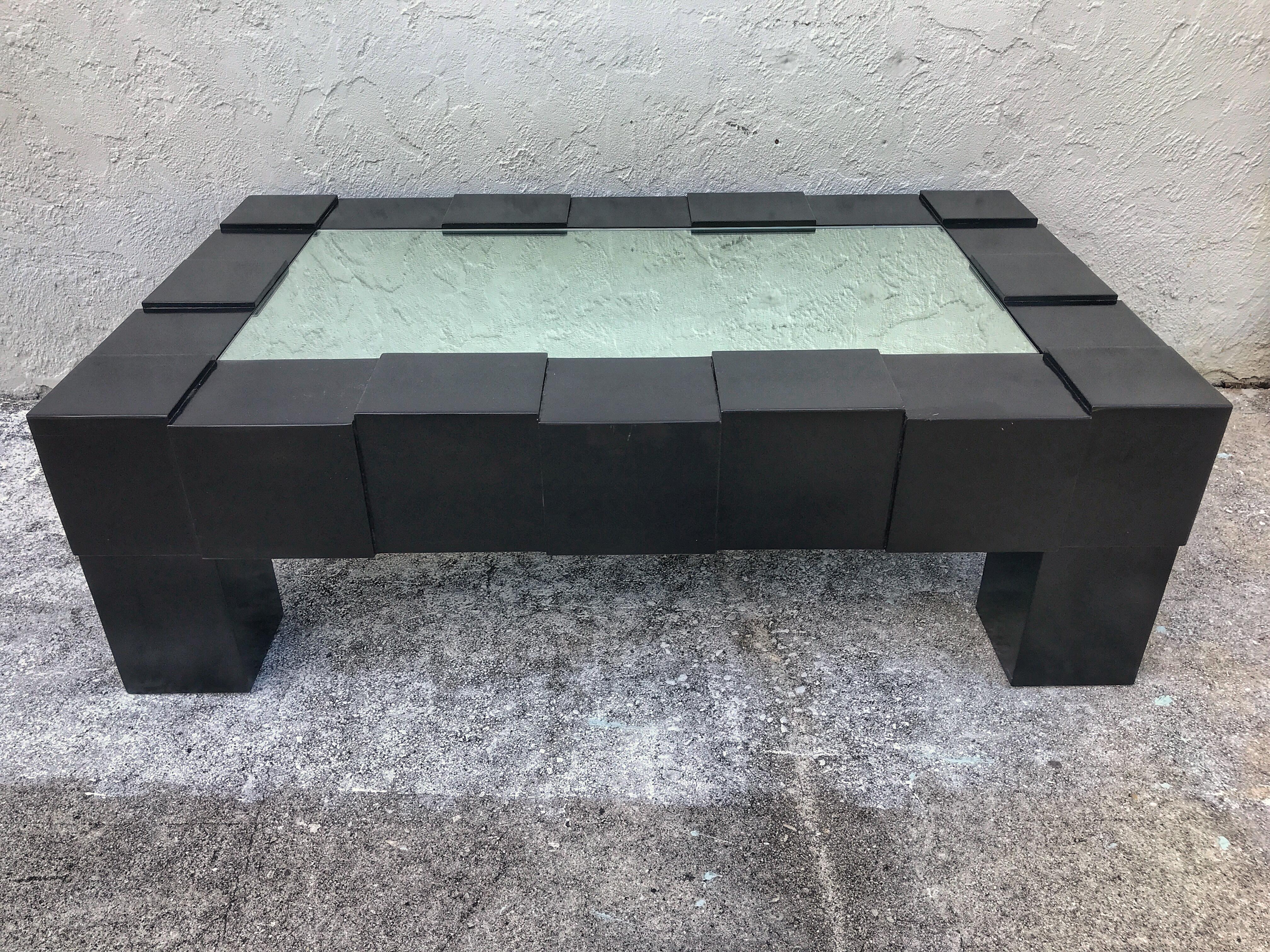 Black lacquered and mirrored coffee table in the manner of Josef Hoffmann, of rectangular form fitted with a x mirror top, raised on stepped cube legs.
