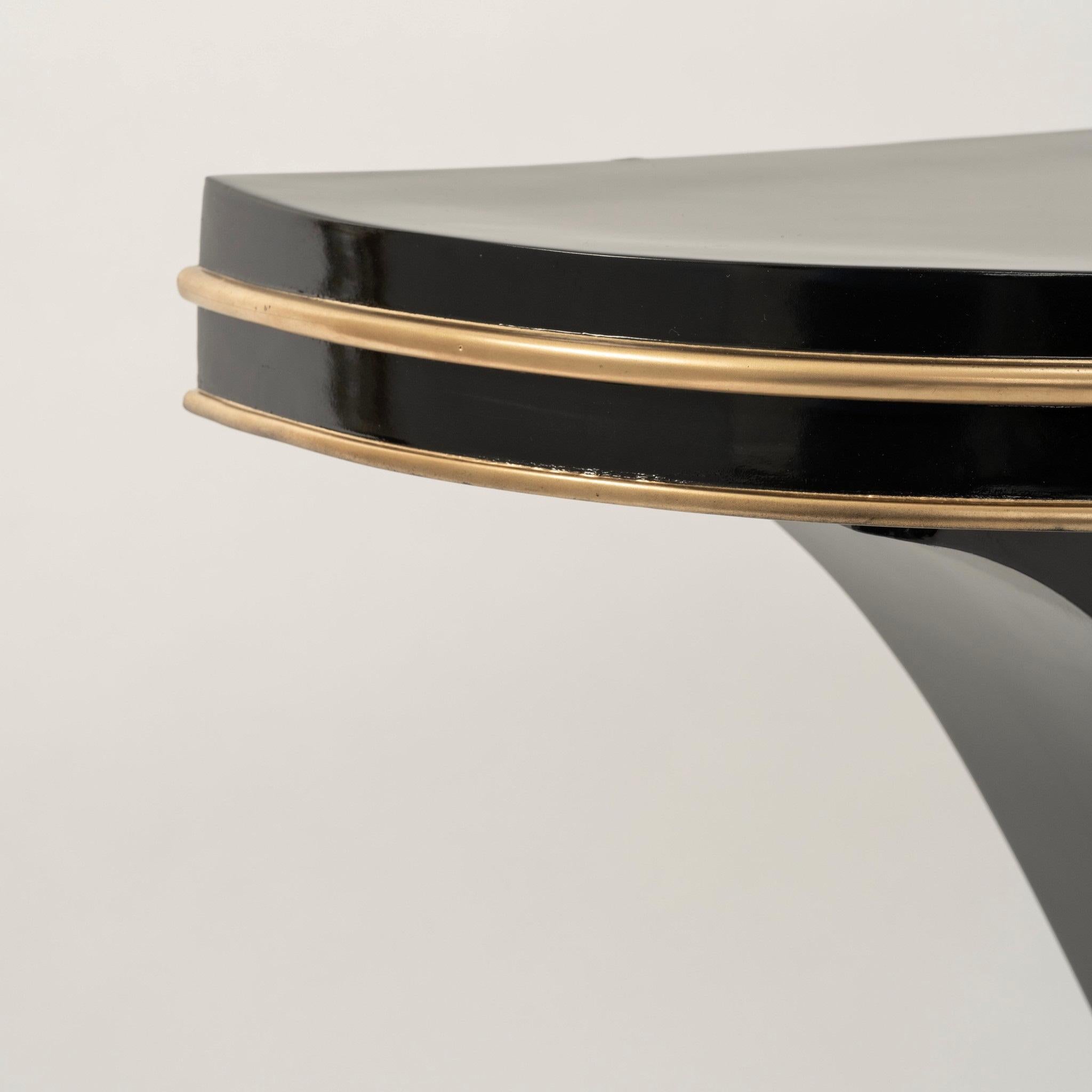 20th century black lacquered Art Deco style console with gold accents.