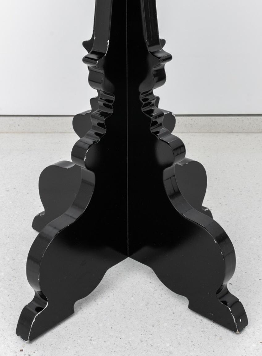 Baroque Revival black lacquered table in the manner of Kartell, with X form molded base in the manner of the Italian Baroque beneath a round top. 30
