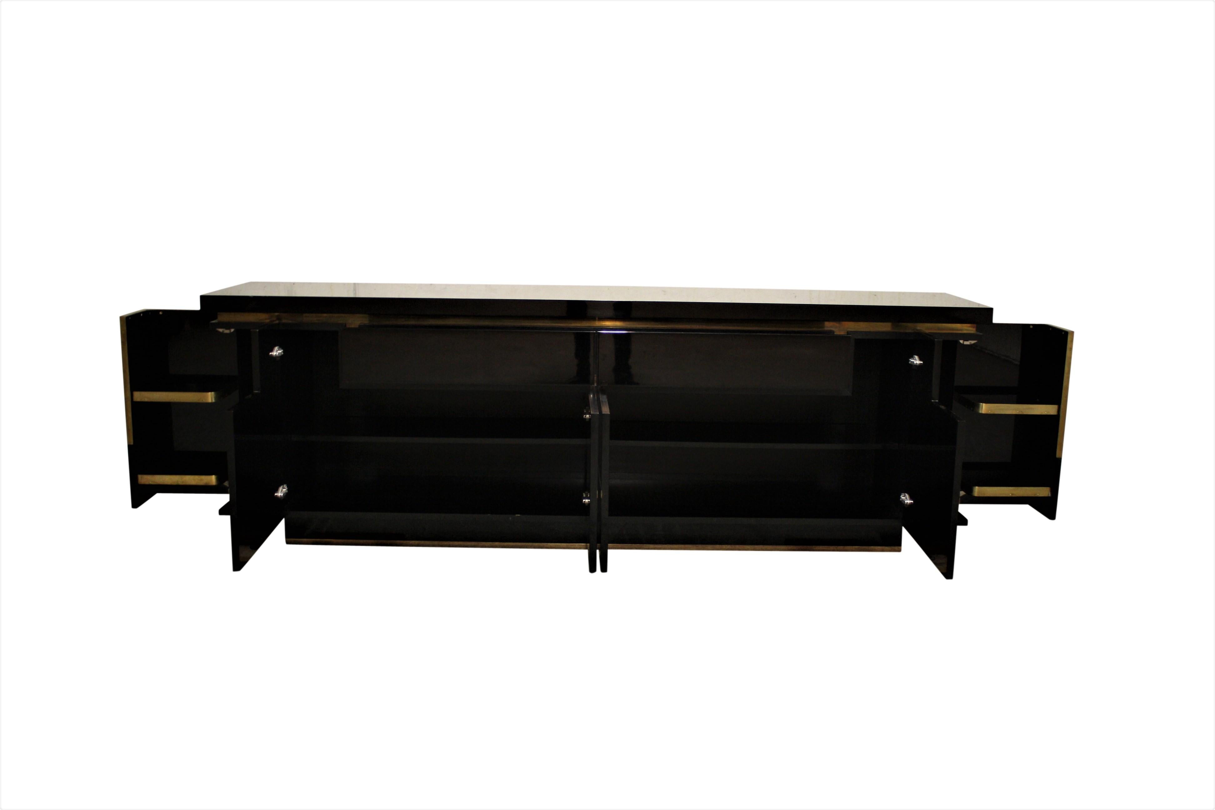 The credenza is made from high gloss mirroring black piano lacquer and copper.

It features two drawers and four doors and 2 bar compartments that open in an unusual way.

Altogether, this beautiful piece is a true eye catcher and a great