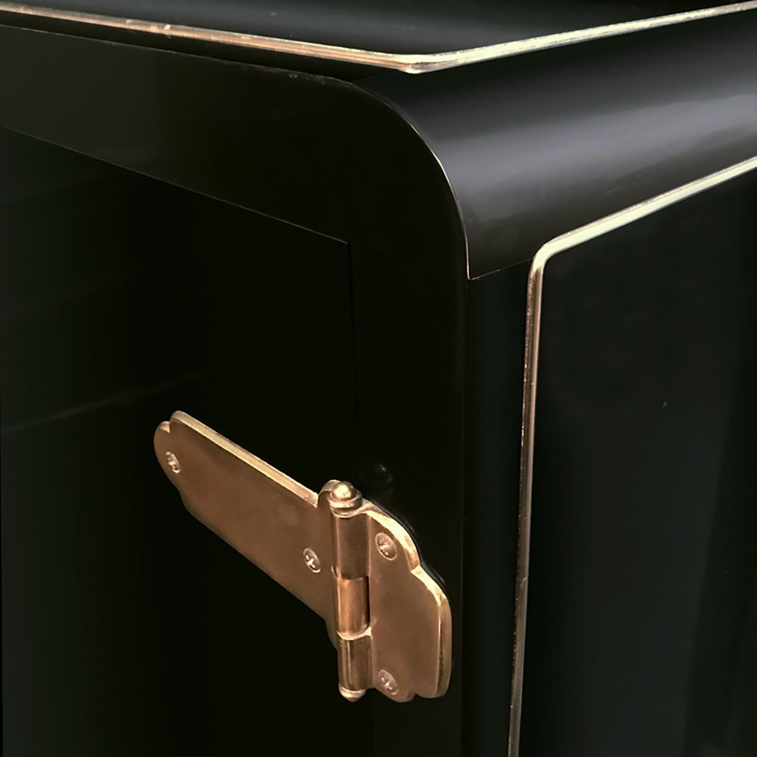 Black lacquered credenza with two doors and brass Asian-style hardware by Mastercraft. USA, 1970s.