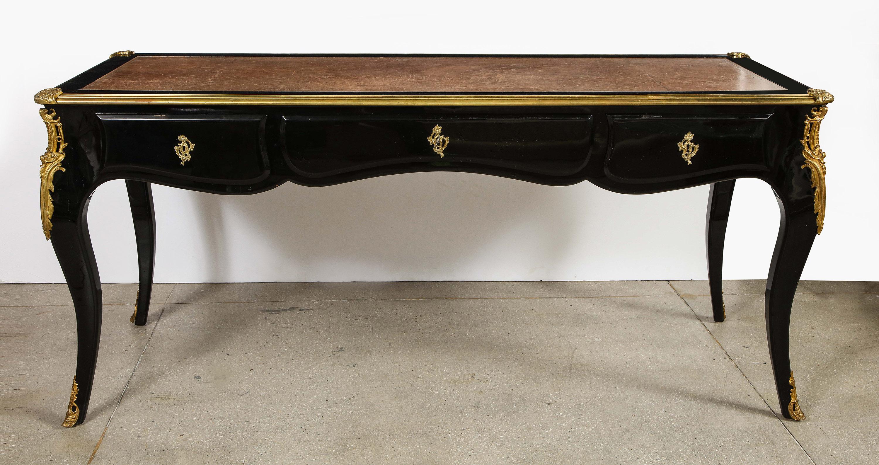 Louis XV style black lacquer Bureau plat

French 19th century Louis XV style black lacquer Bureau plat, raised on bronze mounted cabriole legs, the scalloped shaped frieze with three drawers each with an ormolu escutcheon, the rear and sides