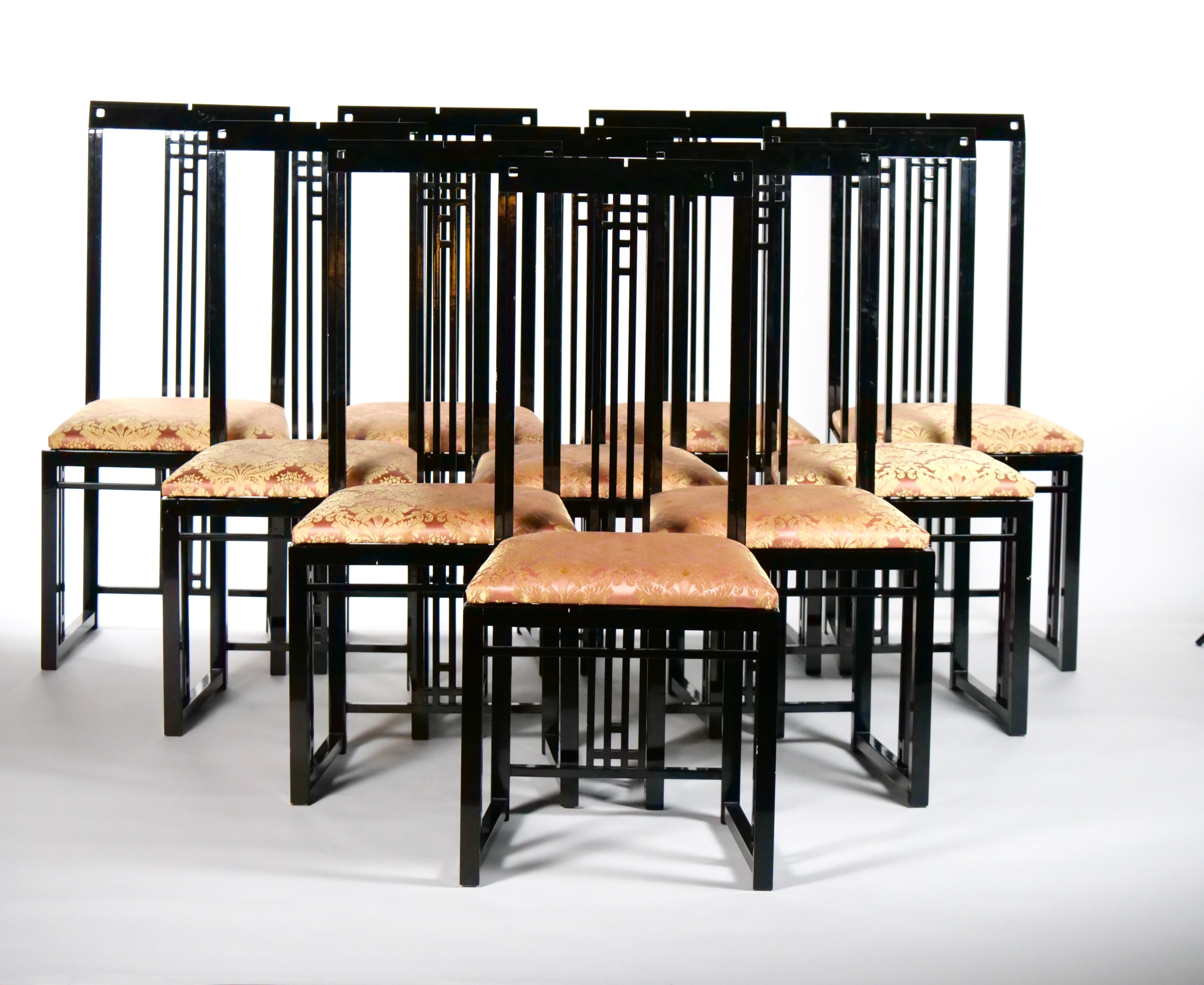 Clean line beautifully executed and handsome black lacquered wood set of ten dining chair with a salmon silk blend upholstered seat. Each chair is crafted in the manner of Charles Rennie Macintosh ( Scottish, 1868-1928 ) Each chair features a
