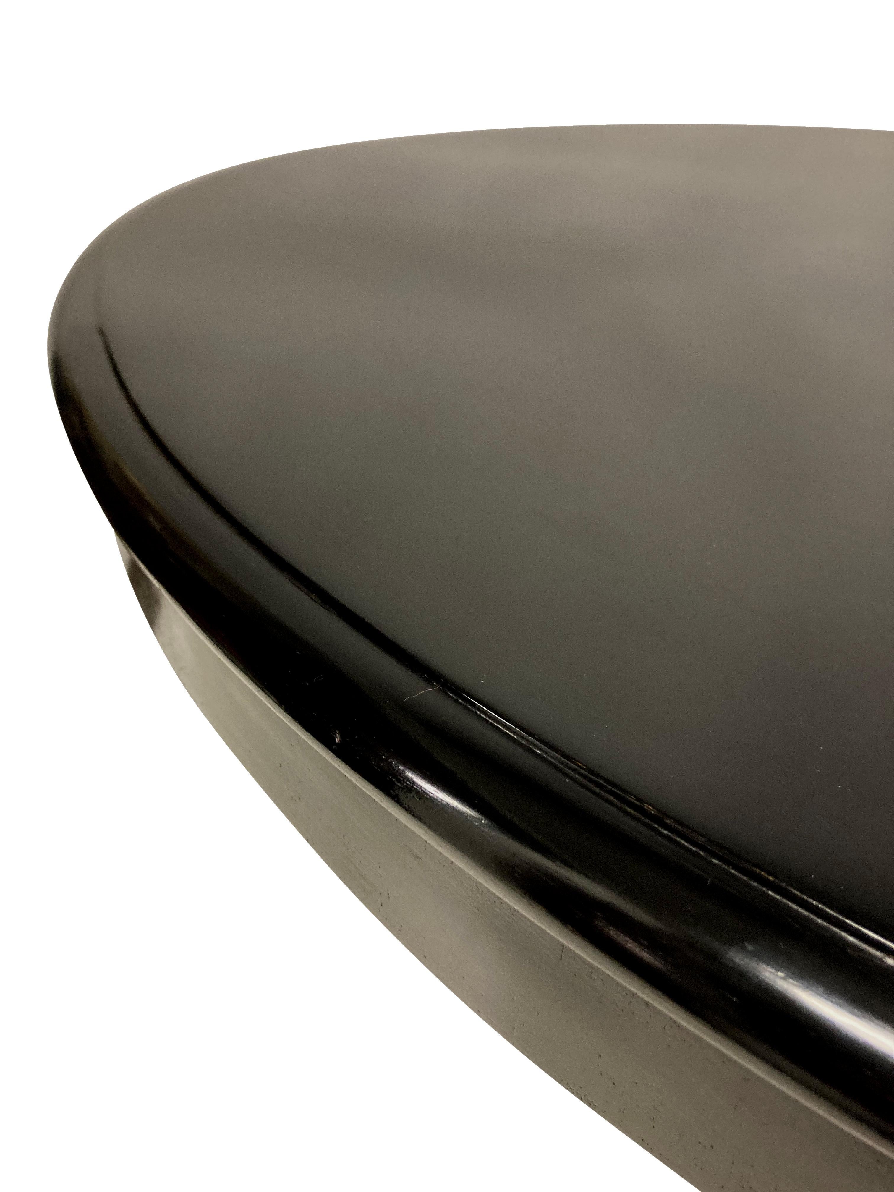 A French black lacquered gueridon table, with a tilt-top on a fluted tapering pedestal and triform base.