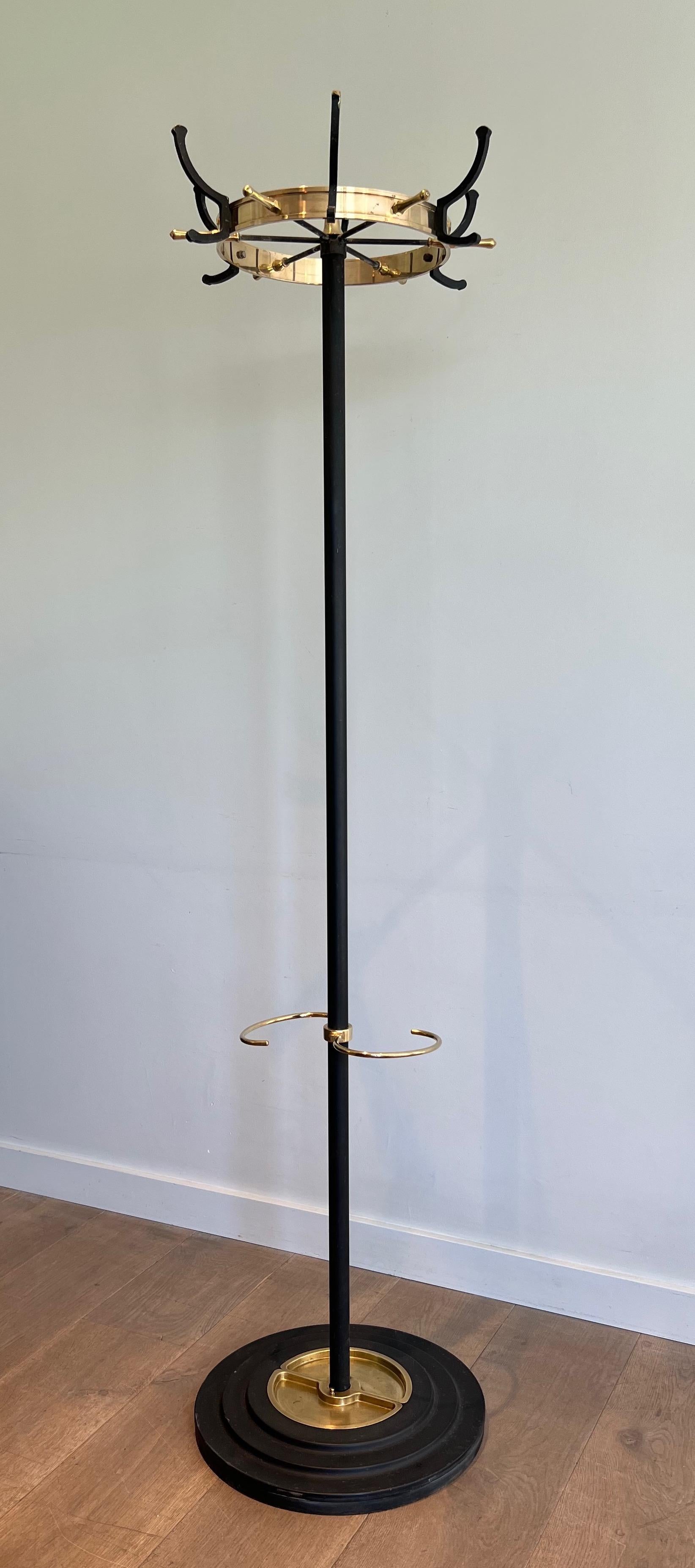 This very nice coat hanger is made of black lacquered metal and brass. There is an umbrella stand on the bottom part. This is a model by famous French designer Jacques Adnet. Circa 