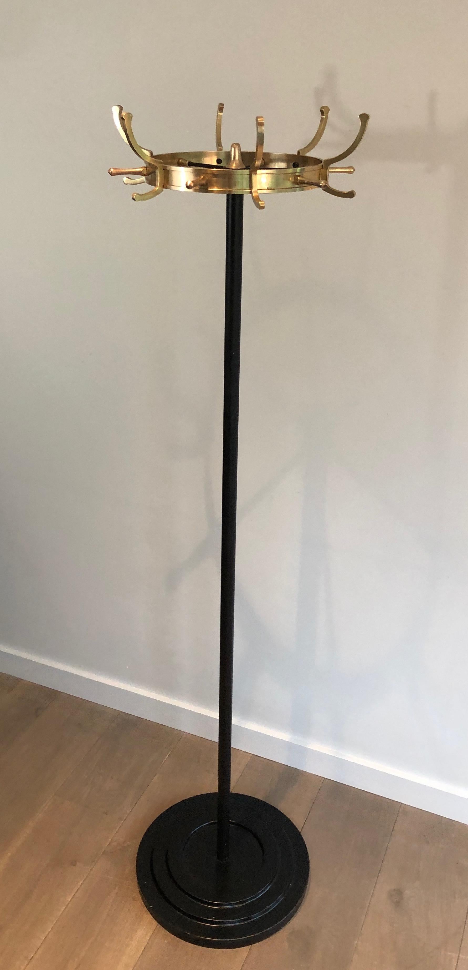 This coat rack is made of black lacquered metal and brass. This is a French work by famous designer Jacques Adnet. Circa 1950.