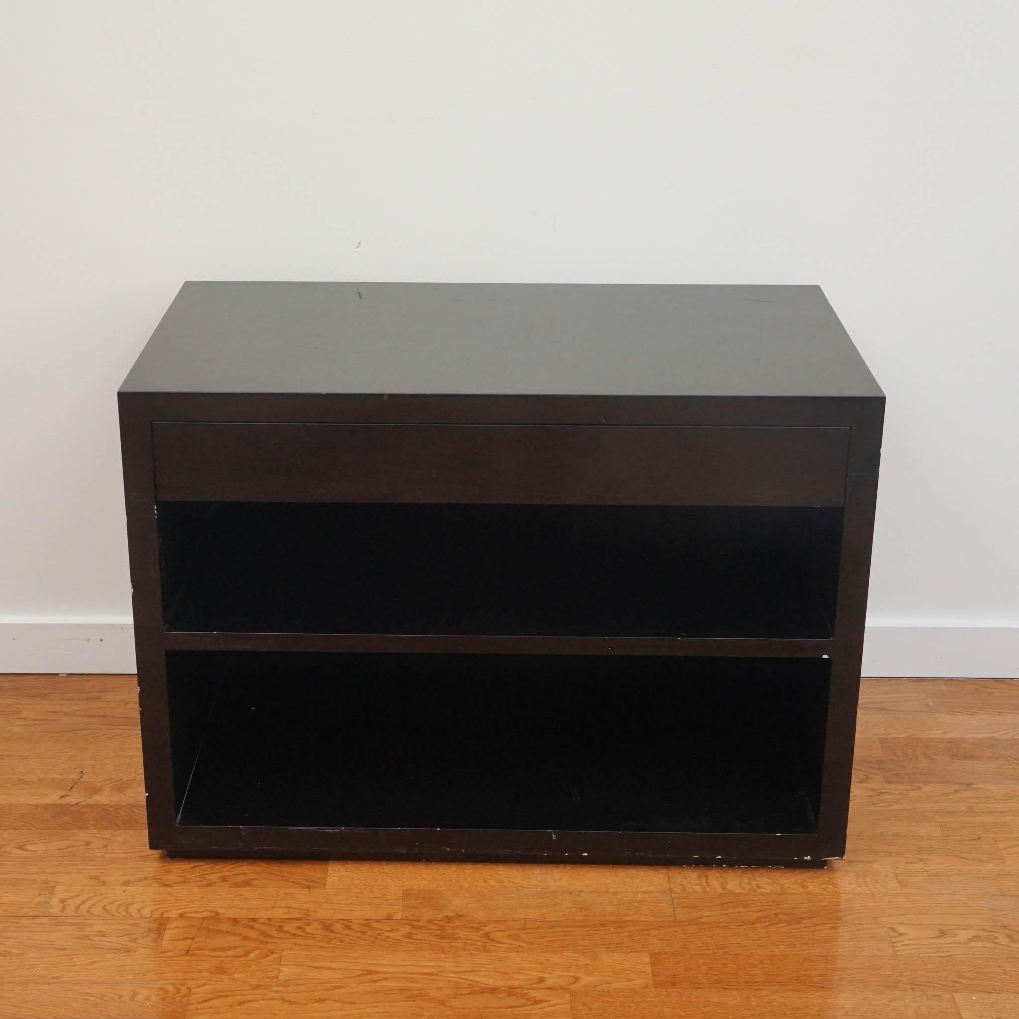 Stunning black lacquered one drawer nightstand done by Paul J. Ebbits. 
Even with its wear and tear, its elegant piano finish is eye-catching! 

Sold as is. 

Measurements: 
width: 36