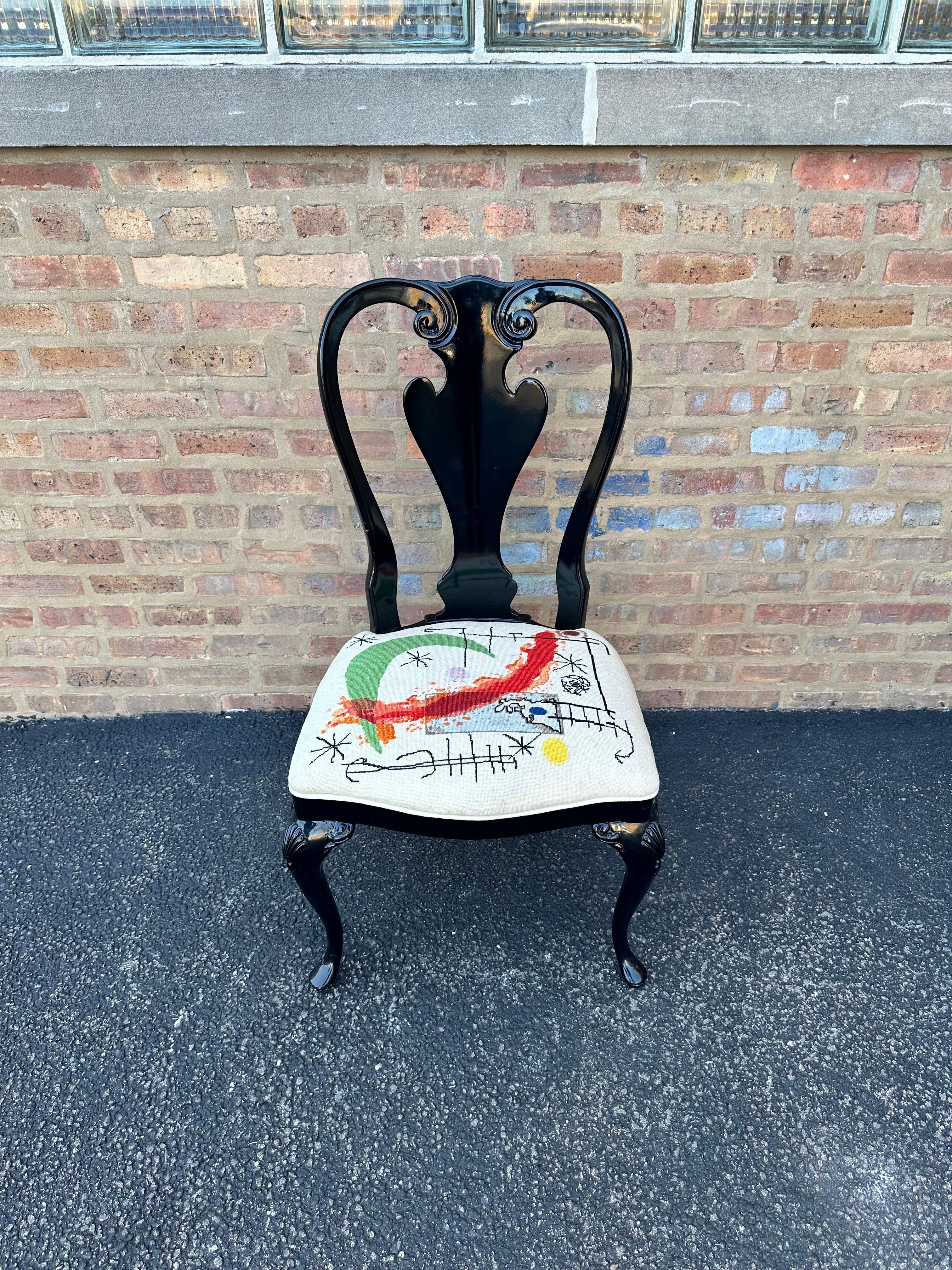 Black Lacquered Queen Anne Dining Chairs with Custom Miró Needlepoint Seats

A set of 8 black lacquered Queen Anne style dining chairs with custom-made needlepoint seats featuring the art of Spanish artist Joan Miró (1893-1983). Chairs have a smooth