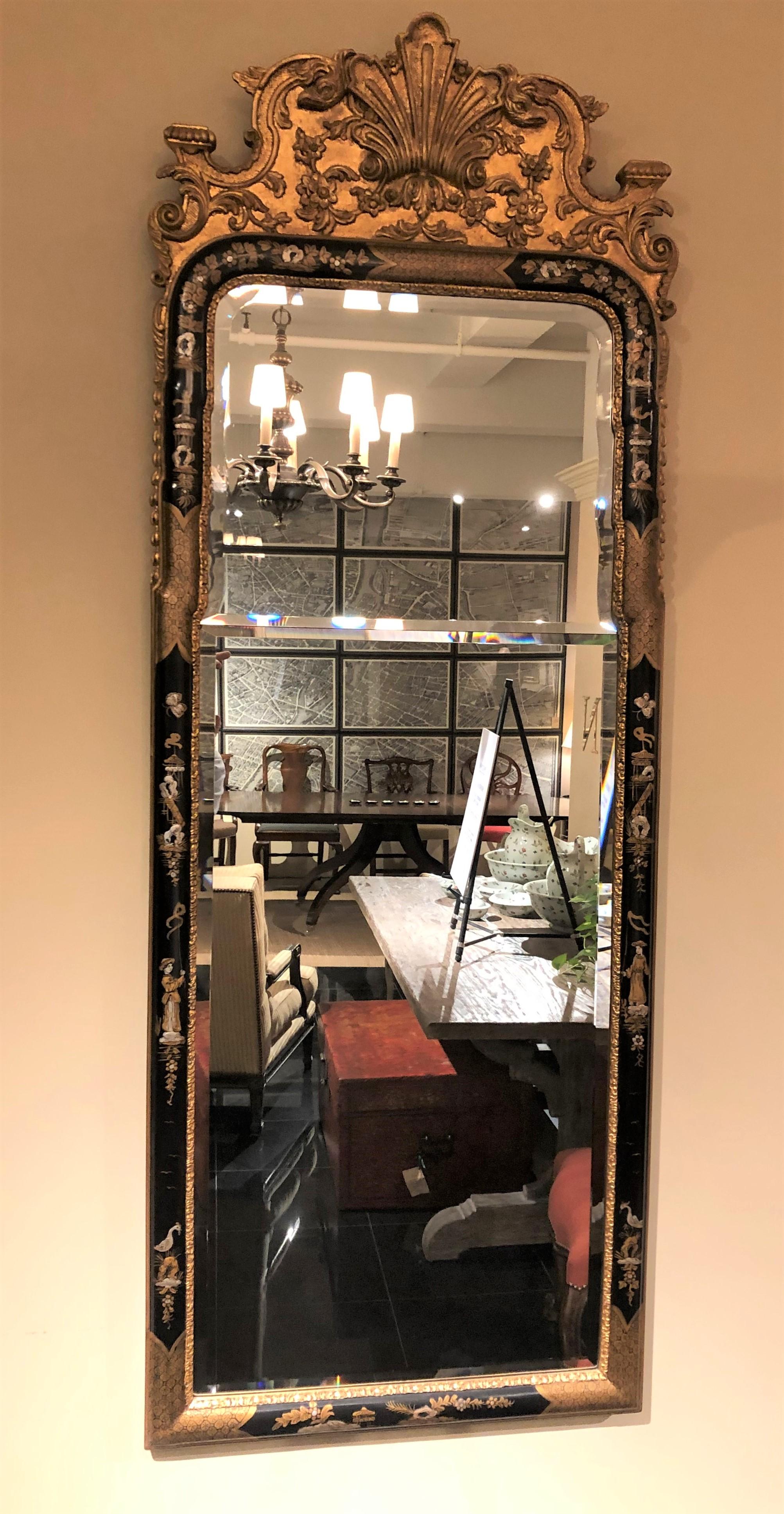 Very fine and decorative black lacquered and gold metal leaf Queen Anne style mirror with hand painted chinoiserie decoration and double bevel glass.
