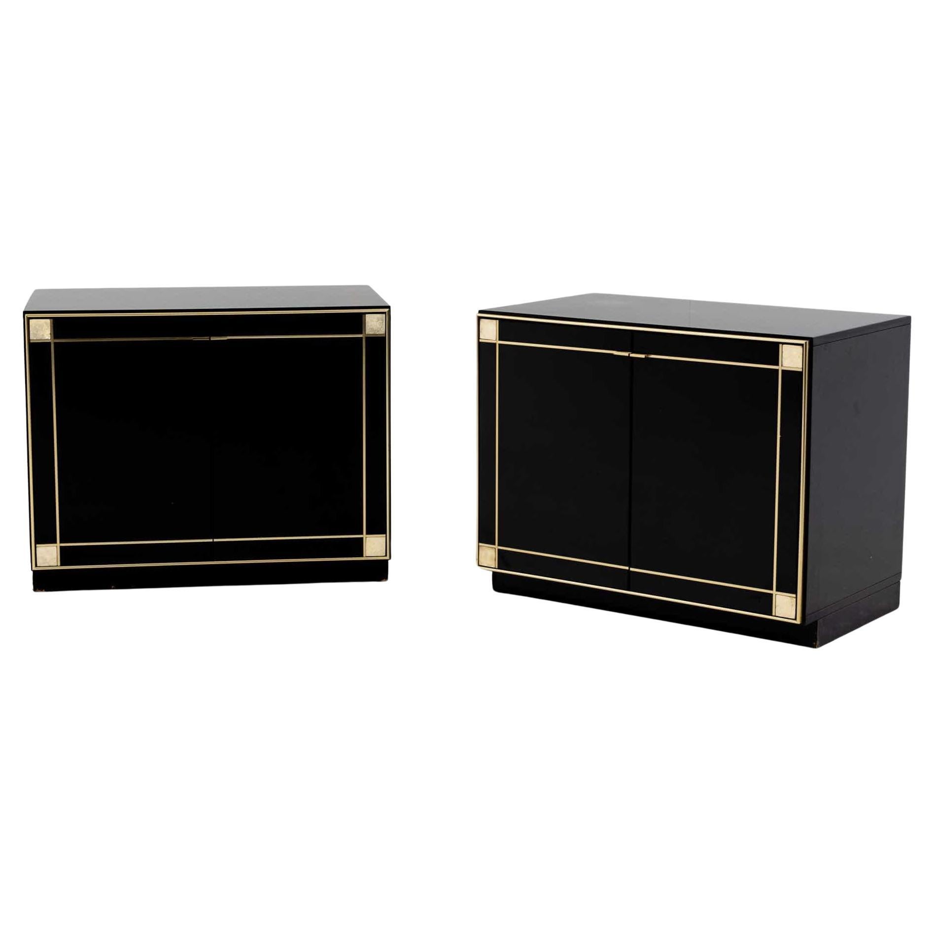 Pair of black lacquered two-door sideboards designed by Pierre Cardin in the 1980s. The sideboards exude an elegant character and are accentuated by brass decorations on the doors. The interior division consists of a shelf.