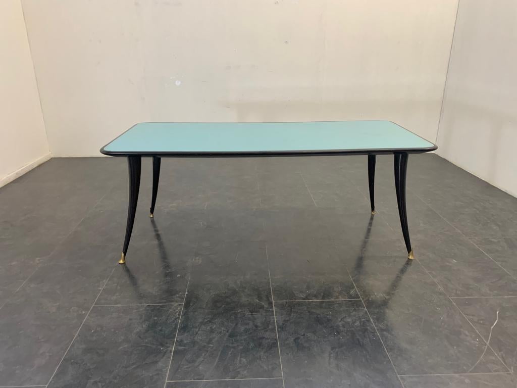 Black lacquered rectangular table with turquoise glass top and elegant sabre legs with brass tips.
Packaging with bubble wrap and cardboard boxes is included. If the wooden packaging is needed (crates or boxes) for US and International Shipping,