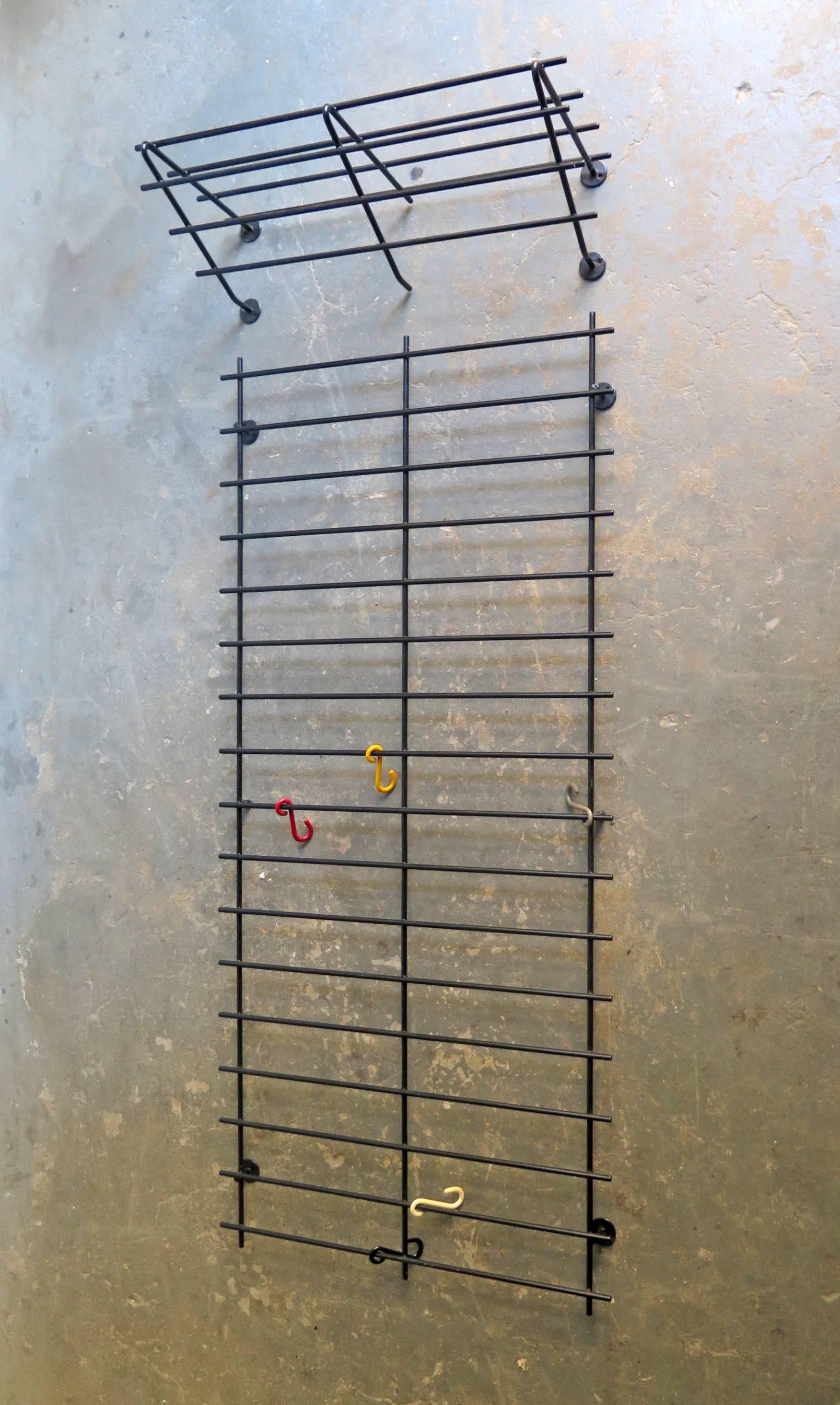 Black lacquered wire metal wall hanger with colorful hooks consisting in two parts.