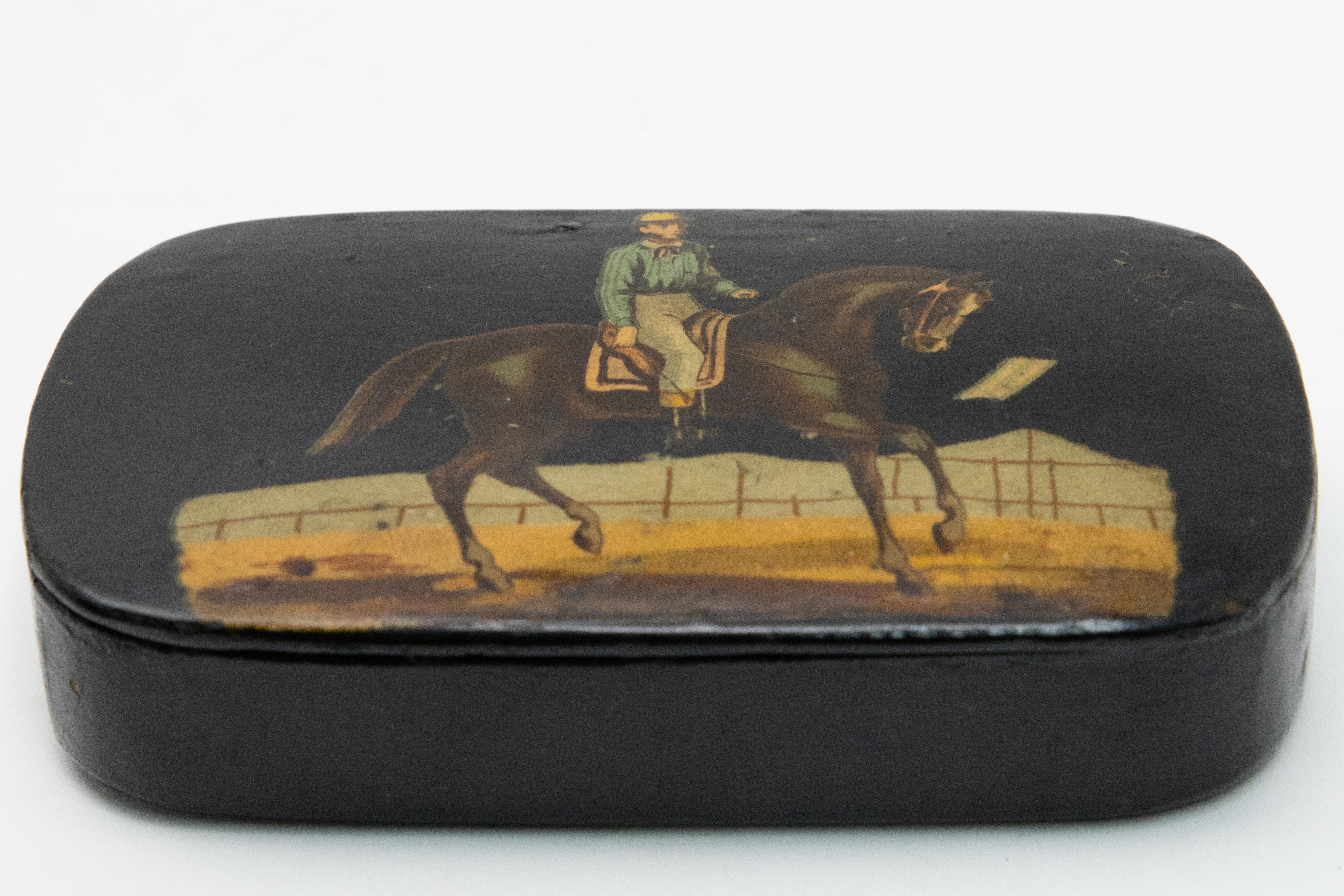 Beautiful black lacquered snuff box. Hand painted scene with jockey and horse. Opened all the inside in lacquered as well.