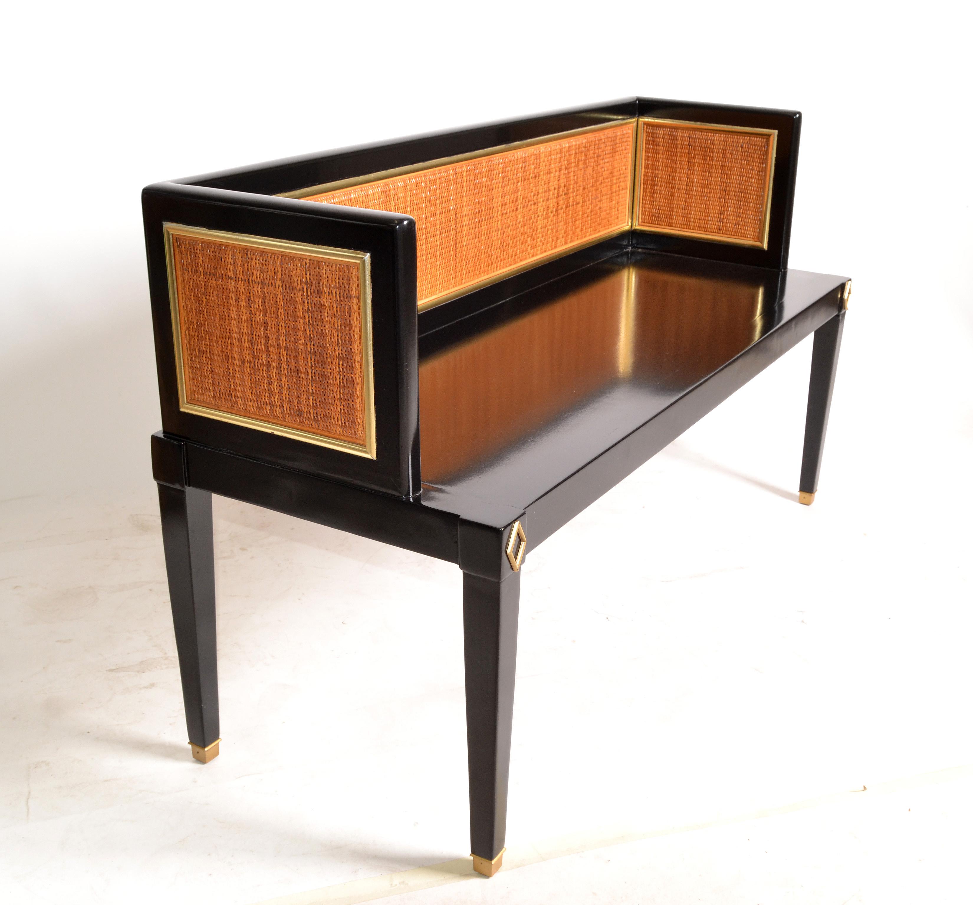 Chinoiserie inspired Mid-Century Modern rectangular seating bench in Black Lacquer.
The Bench features a wooden frame with woven cane backrest.
The legs have brass covers.
Completely restored and ready for Your Home.
Lovely 1970s Asian influenced