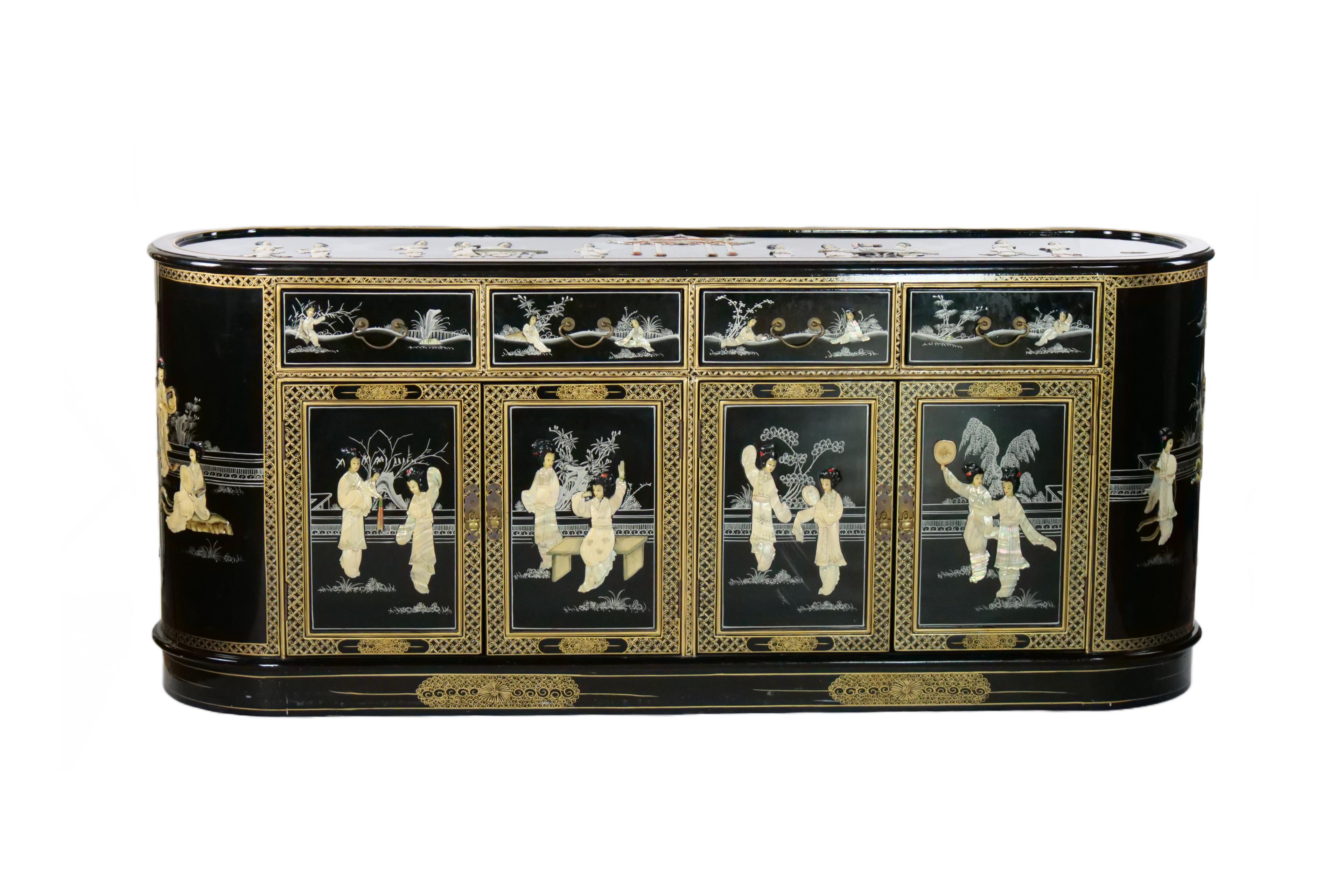 Beautifully hand painted and decorated black lacquered wood chinoiserie scene detail sideboard / credenza. The sideboard features four front pull top drawer resting on four double bottom door. Each drawer is lined with green velvet fabric. The