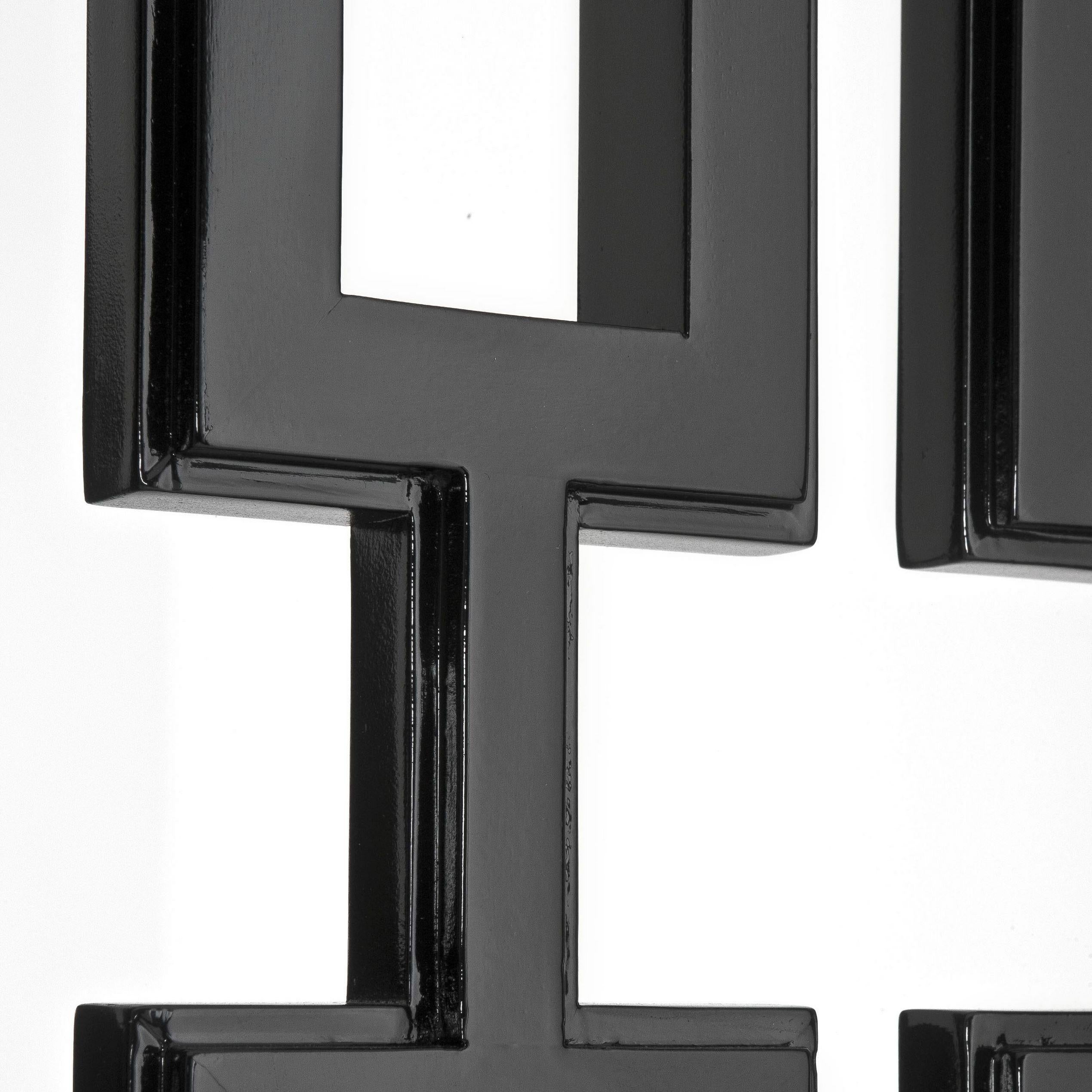 Graphic and highly decorative folding screen divider in black lacquer finish with stainless steel feet.