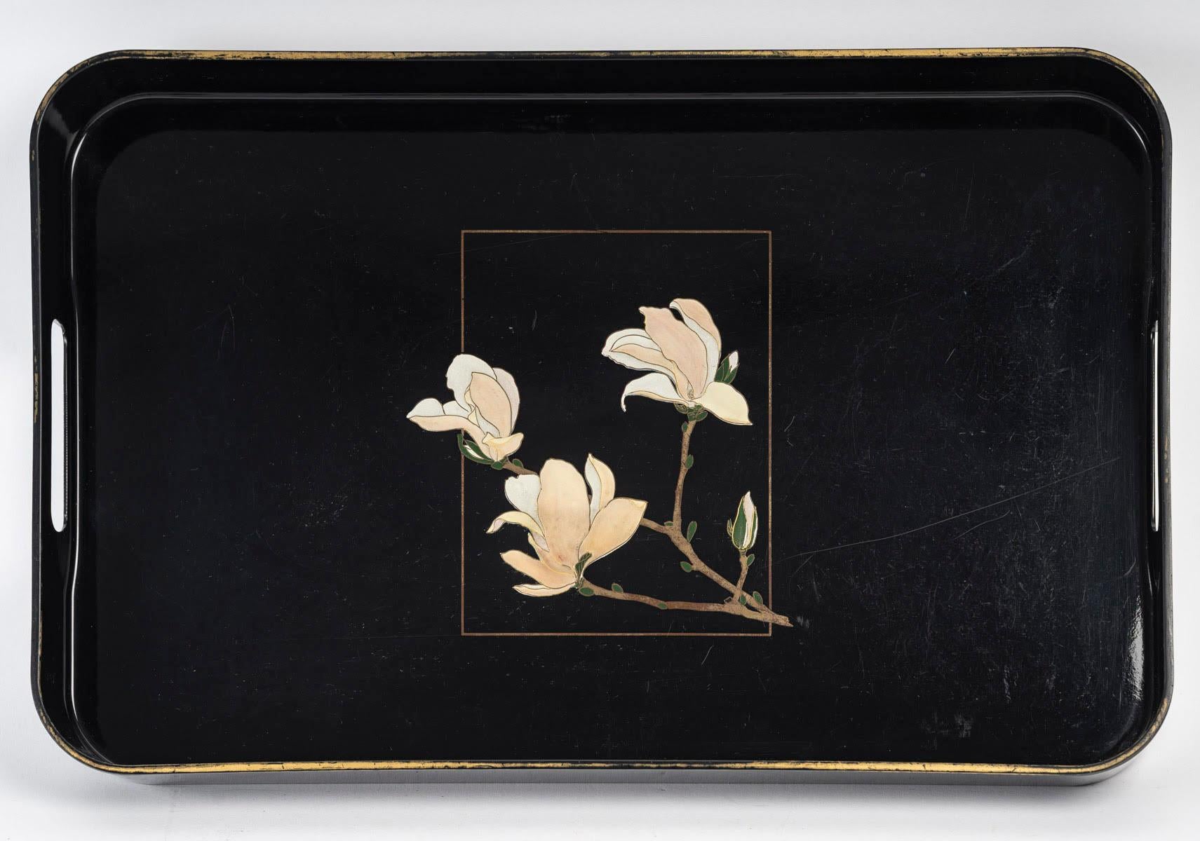 Black lacquered wooden tray with floral motifs, circa 1980.

Lacquered wooden tray from the 1980s with pretty floral motifs in the centre.
h: 4.5cm, w: 54cm, d: 34cm