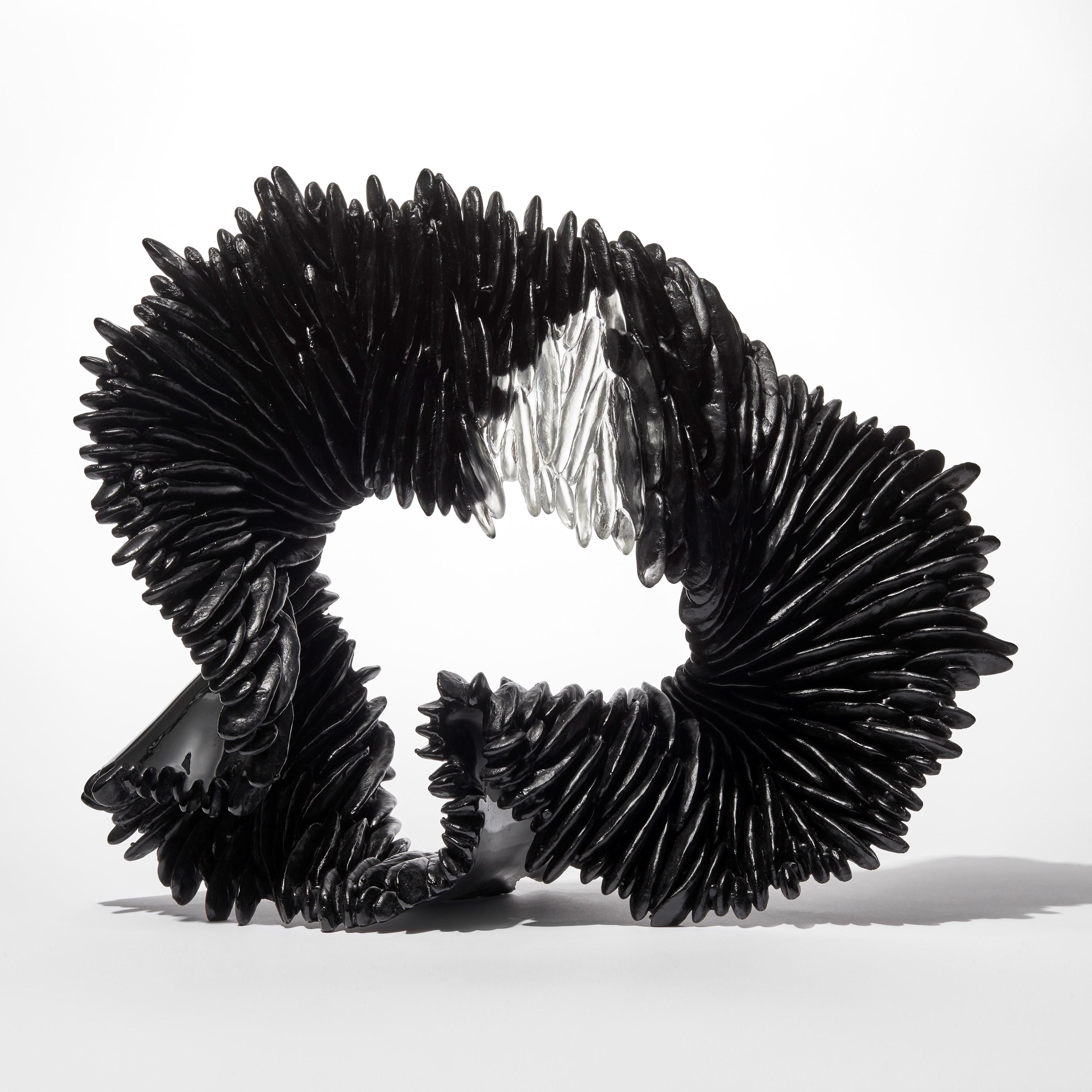 'Black Lamellae' is a unique glass sculpture by the British artist, Nina Casson McGarva.

Casson McGarva firstly casts her glass in a flat mould where she introduces all of the beautifully detailed, scaled surface texture, all unique and to her