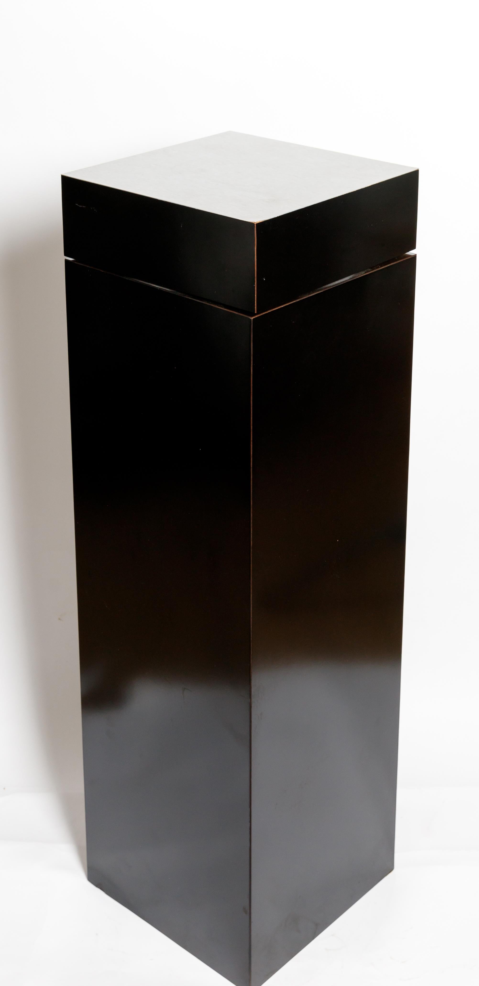 Black laminate and stainless steel pedestal with swivel top.