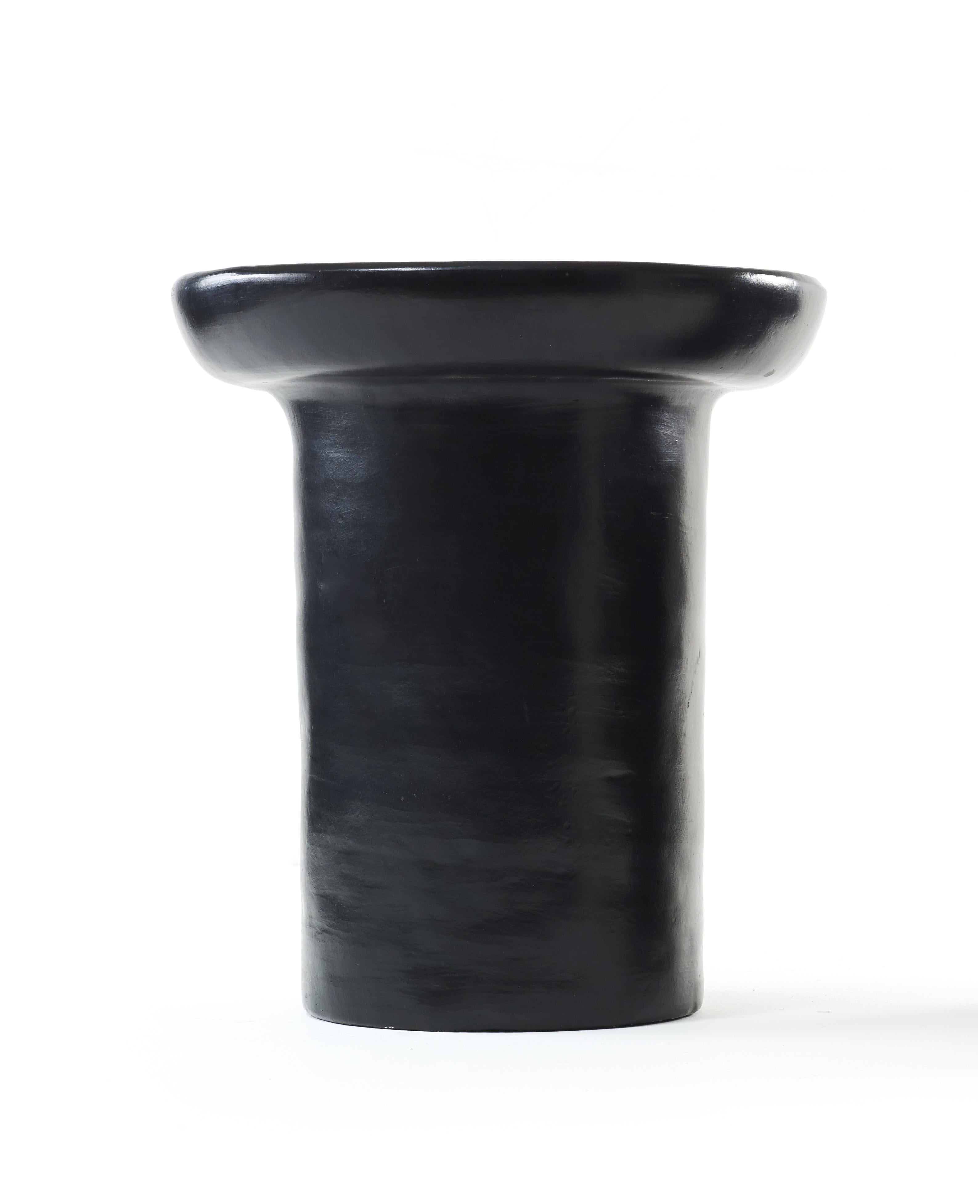 Black large nuna side table by Sebastian Herkner
Materials: Heat-resistant black and red ceramic. 
Technique: Glazed. Oven cooked and polished with semi-precious stones.
Dimensions: Diameter 33 cm x height 40 cm 
Available in colors red, and
