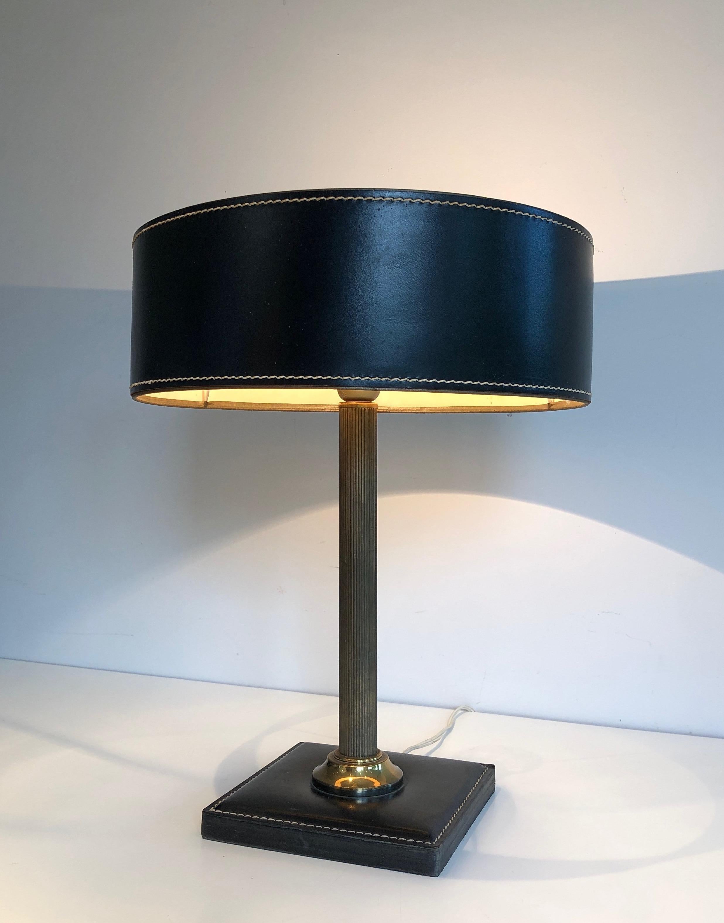 Black leather and brass desk lamp. French work in the style of Jacques Adnet. Circa 1970