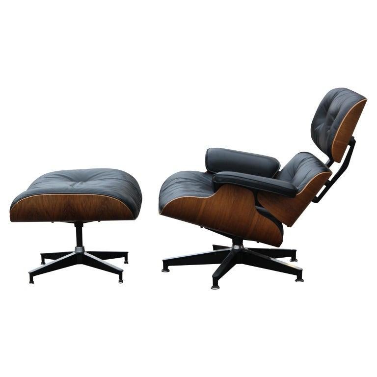 Modern black leather with rosewood Eames lounge chair and ottoman. This chair was produced in the 1970s by Herman Miller.
Dimensions of the ottoman: H 25.5 in x W 22 in x D 17.5 in.