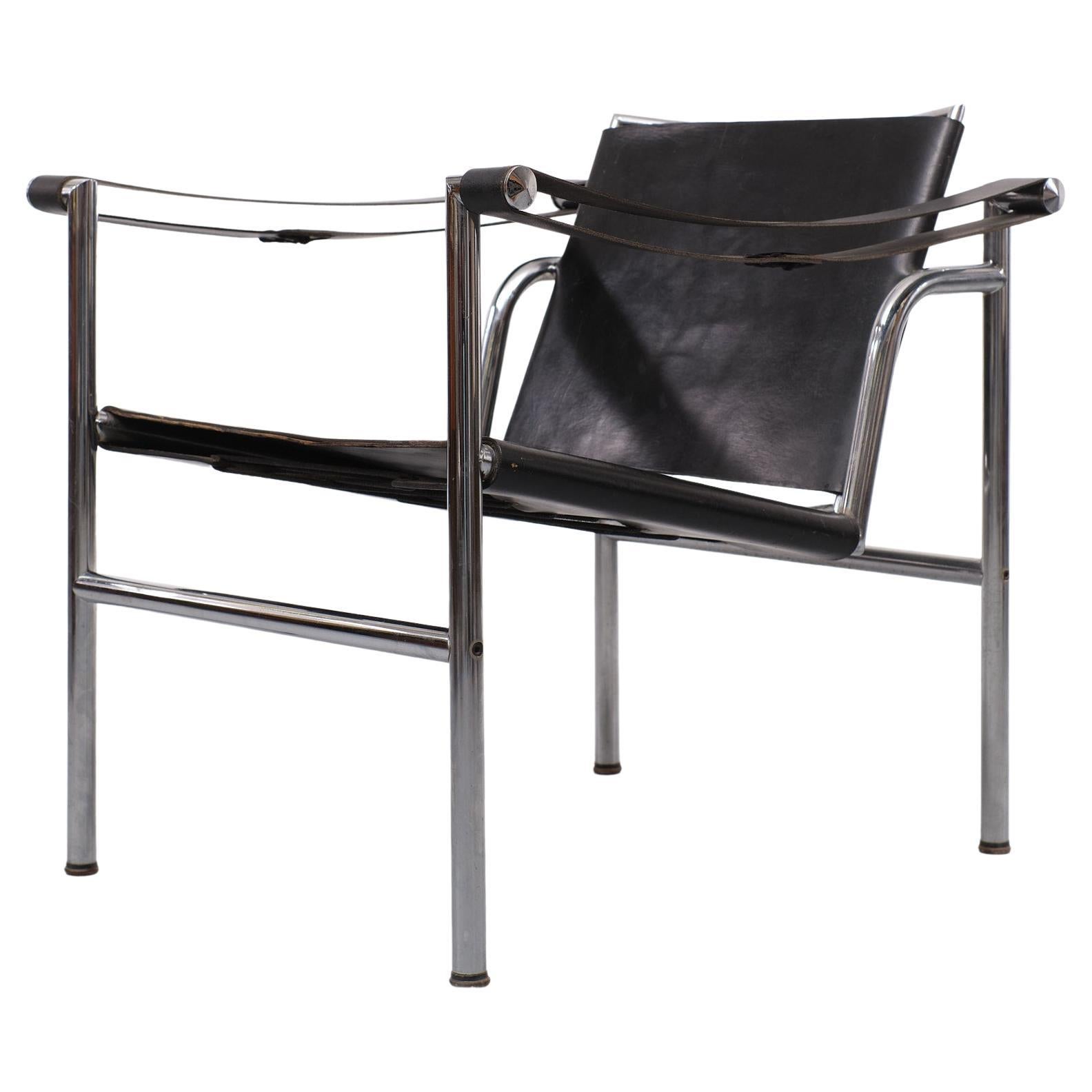 Very nice black leather arm chair. The backrest is moveable. Thick leather 
upholstery. Chrome base. Looks almost the same LC1 chair by Le Corbusier.
Some small differents. This is good quality chair.