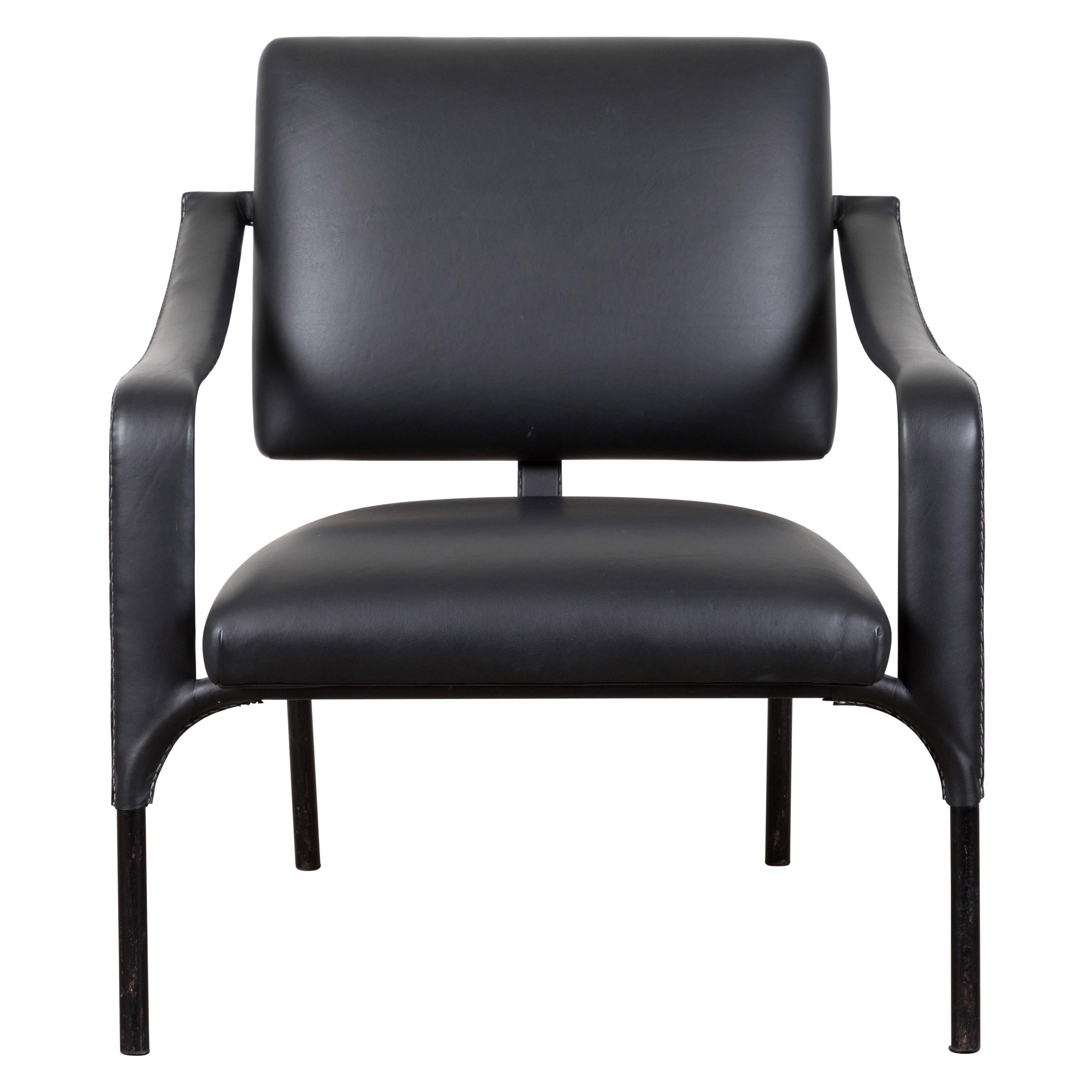 Black leather armchair by Jacques Adnet.
Dimensions: 25.5
