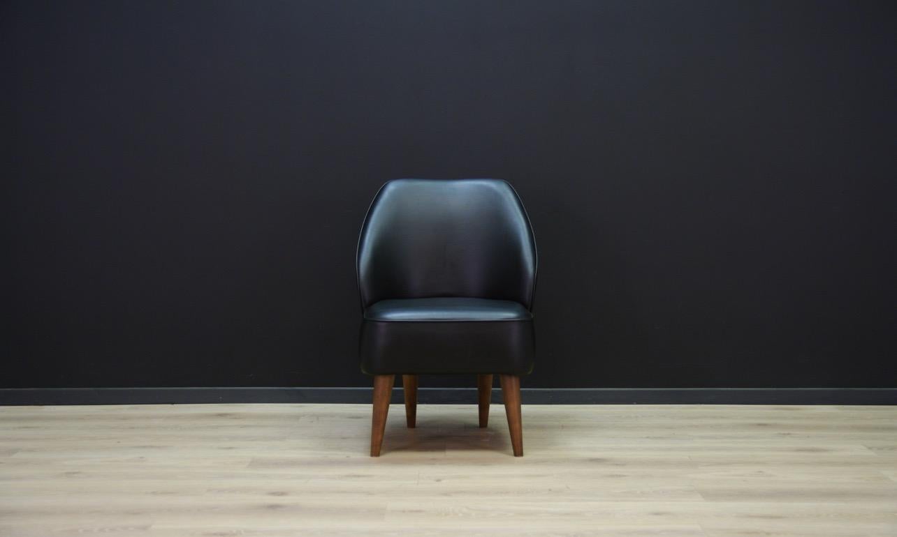 Exceptional chairs from the 1980s and 1990s, a beautiful form. Armchairs covered with ecological leather. Legs made of solid wood. Maintained in good condition (abrasions and scratches on the skin, ecological skin glued, traces visible in the