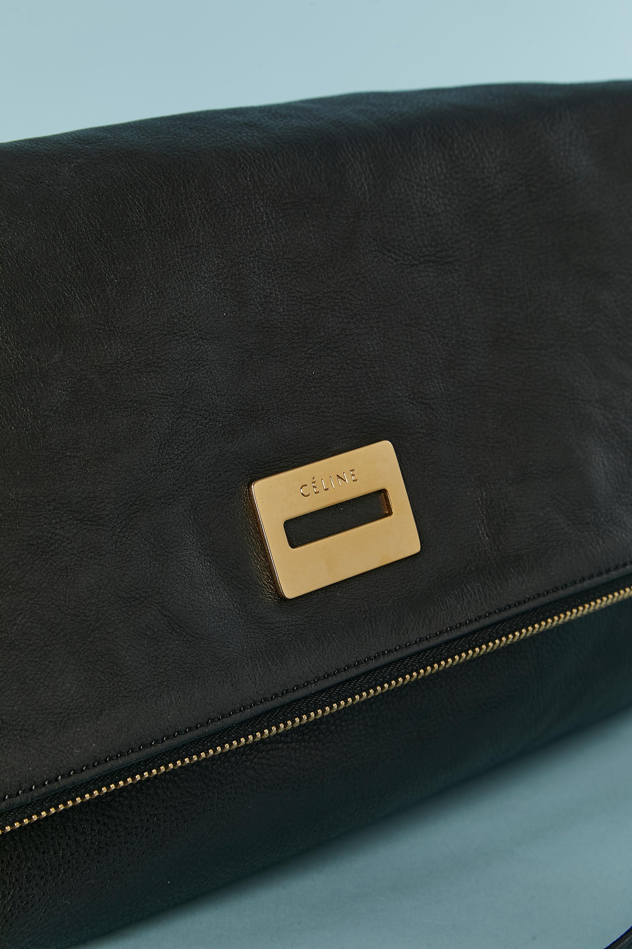 Black leather bag foiled on the top and gold zip closure with leather string zip puller. Black suede side and bottom. Cotton lining. One pocket with zip pocket inside + 2 flat pockets. Top stitched detachable shoulder strap. 
SIZE 40cm X 20cm X 10cm