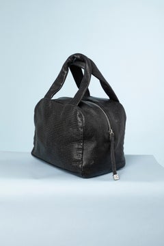 Black leather bag perforated with double C and zip Numbered