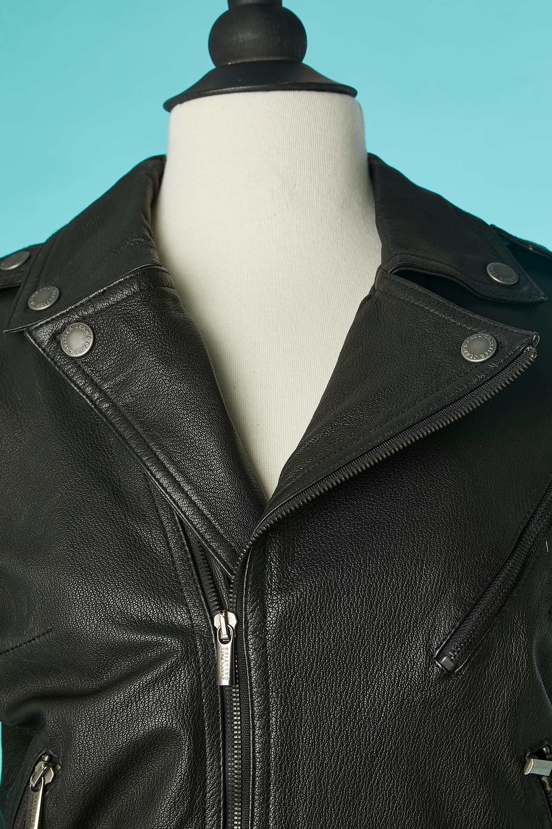 Black leather biker jacket slightly padded. Lining composition: 100% polyester
Zip closure middle front , pockets and cuffs. Branded zip puller and snaps. 
Leather belt, belt-loop and metal buckle 
SIZE S / 36 (Fr) / 6 (Us)