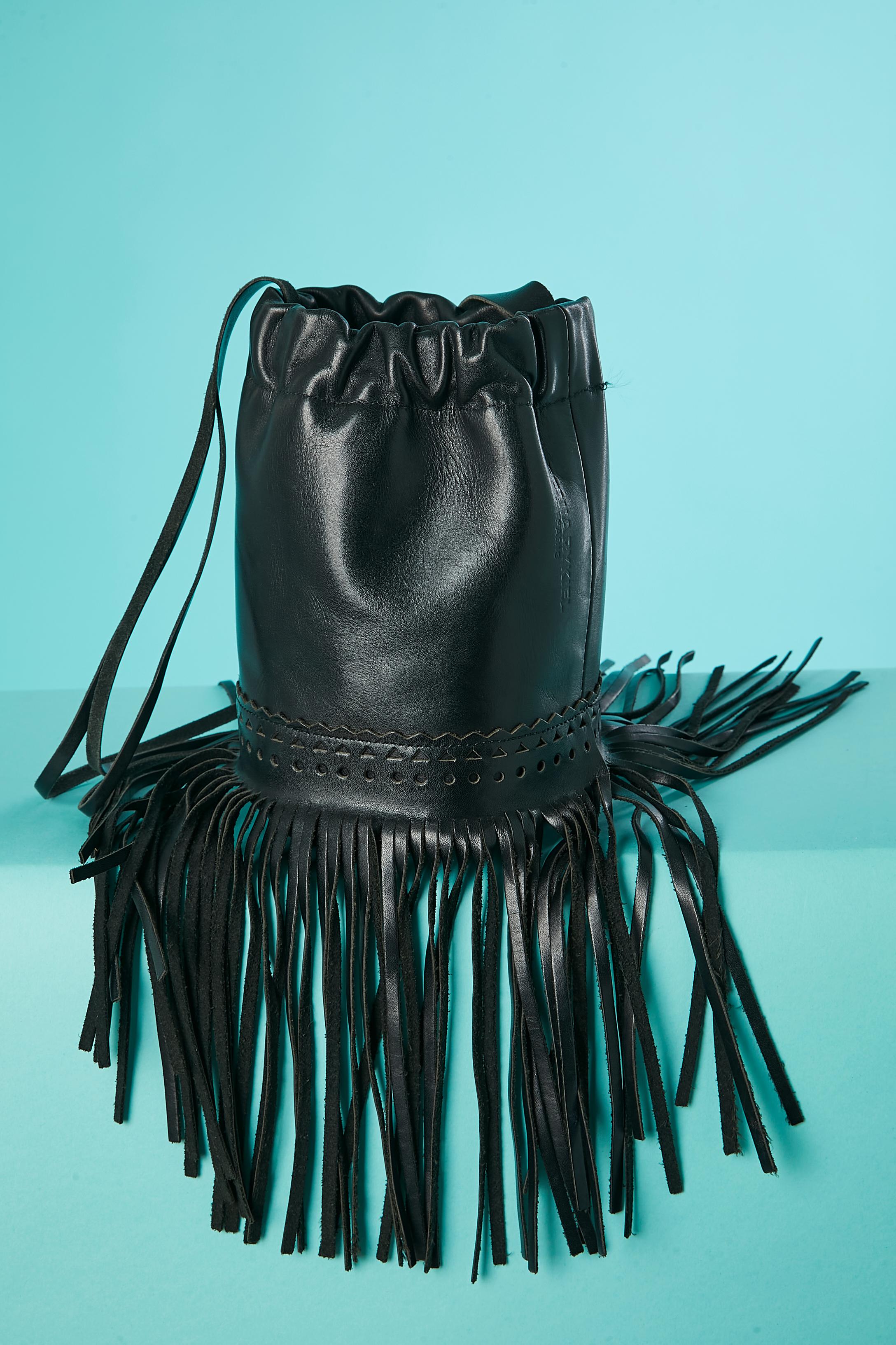 Black leather bucket bag with leather fringes. No lining , suede bottom inside. The shoulder handle is cut in 3 lignes. 
Size: height= 20 cm 
Bottom diameter= 15 cm 
Fringes length= 17 cm 