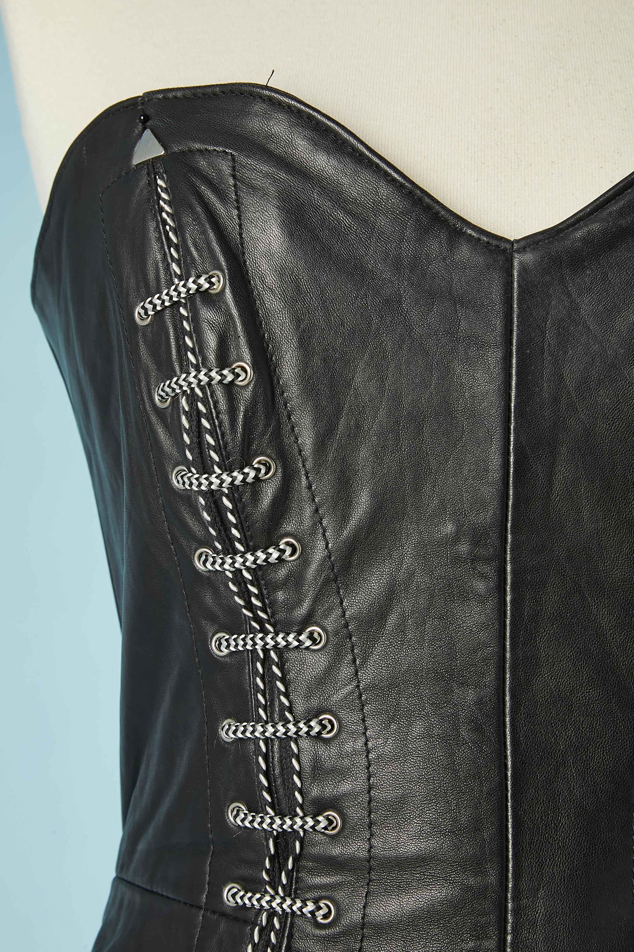 Black leather bustier dress with black&white technical laces and silver metal studs. Zip in the middle back and split in the bottom ( length= 14 cm)
SIZE M 