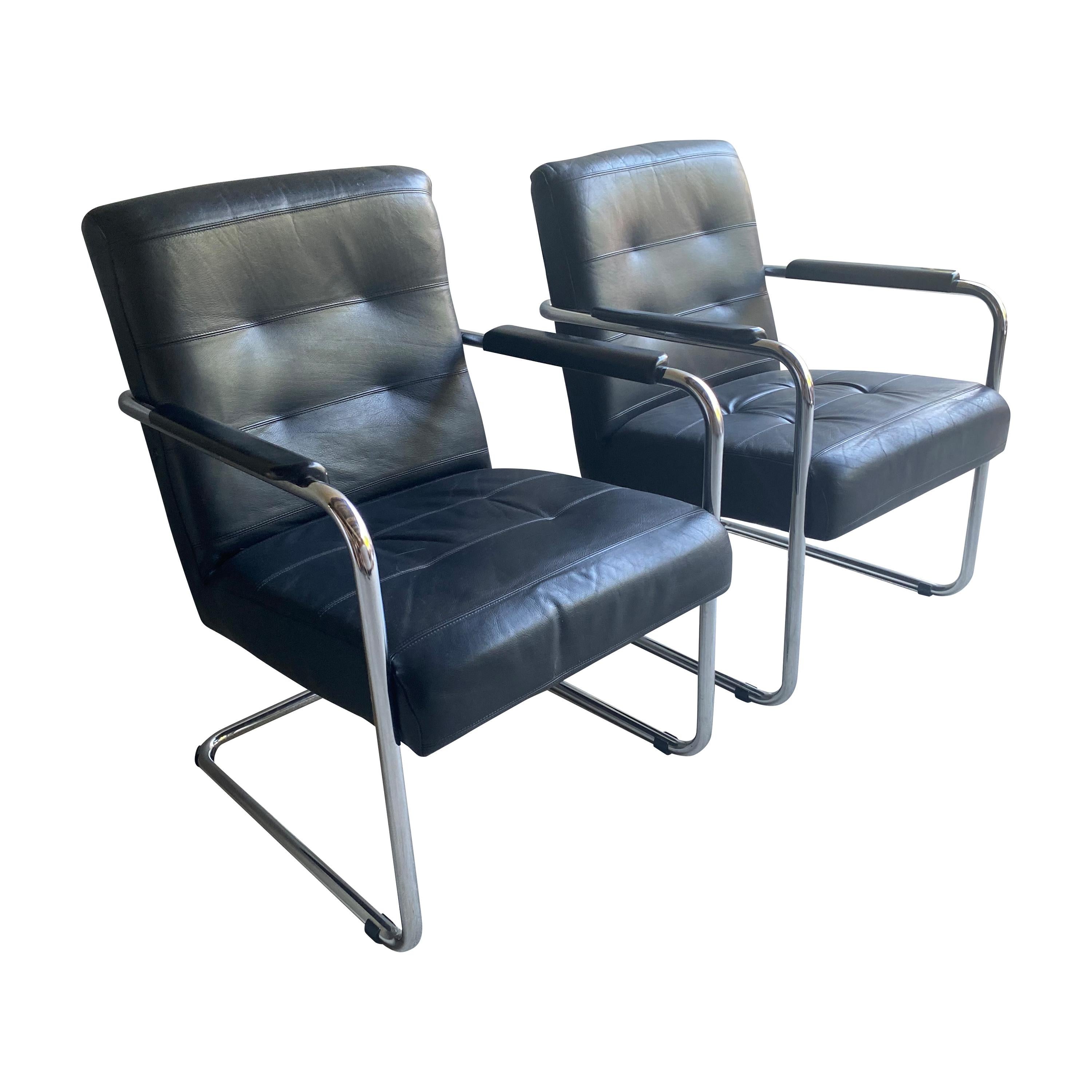 European classic modern armchair in black leather and tubular chrome.  Comfortable with generous scale and slight bounce as a result of the cantilevered design. 1970-80's.  Two available, sold separately.