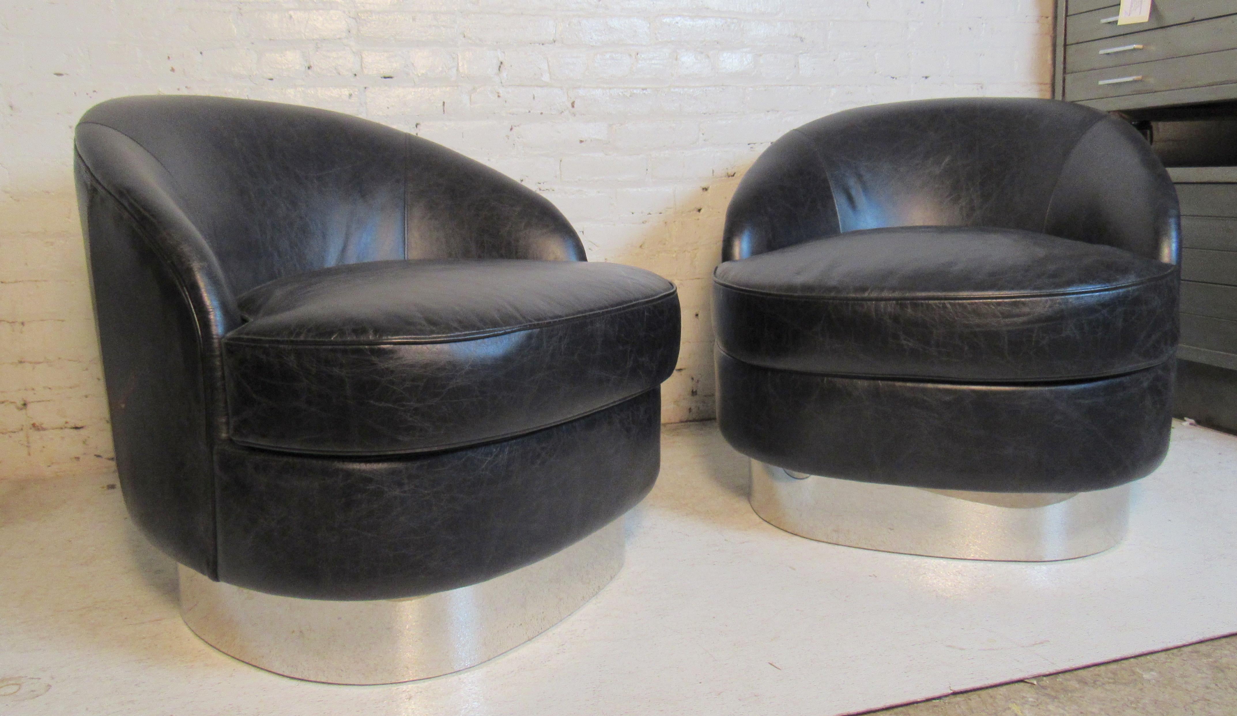 Pair of midcentury style swivel chairs in black with accenting polished chrome base.
(Please confirm item location - NY or NJ - with dealer).
 