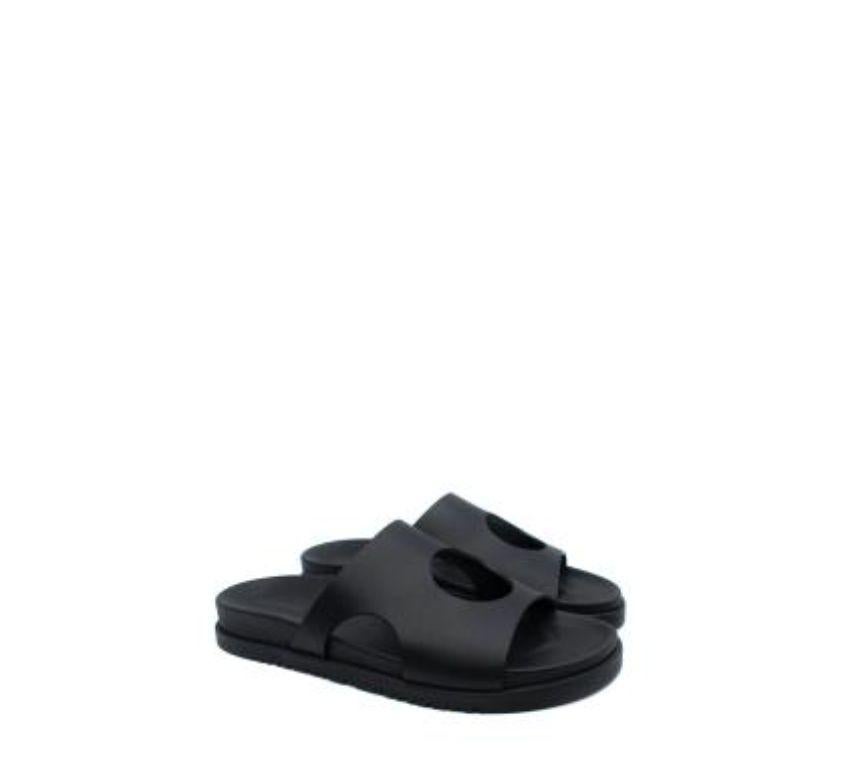 Hermes Black Leather Edith Cut-Out Sandals
 
 Black calfskin leather sandals with circular cut-outs. Black leather lined sculpted footbed, and rubber H embossed sole. Made in Italy. With original packaging.