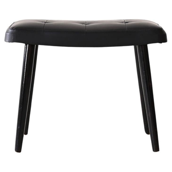 Black leather footstool ottoman