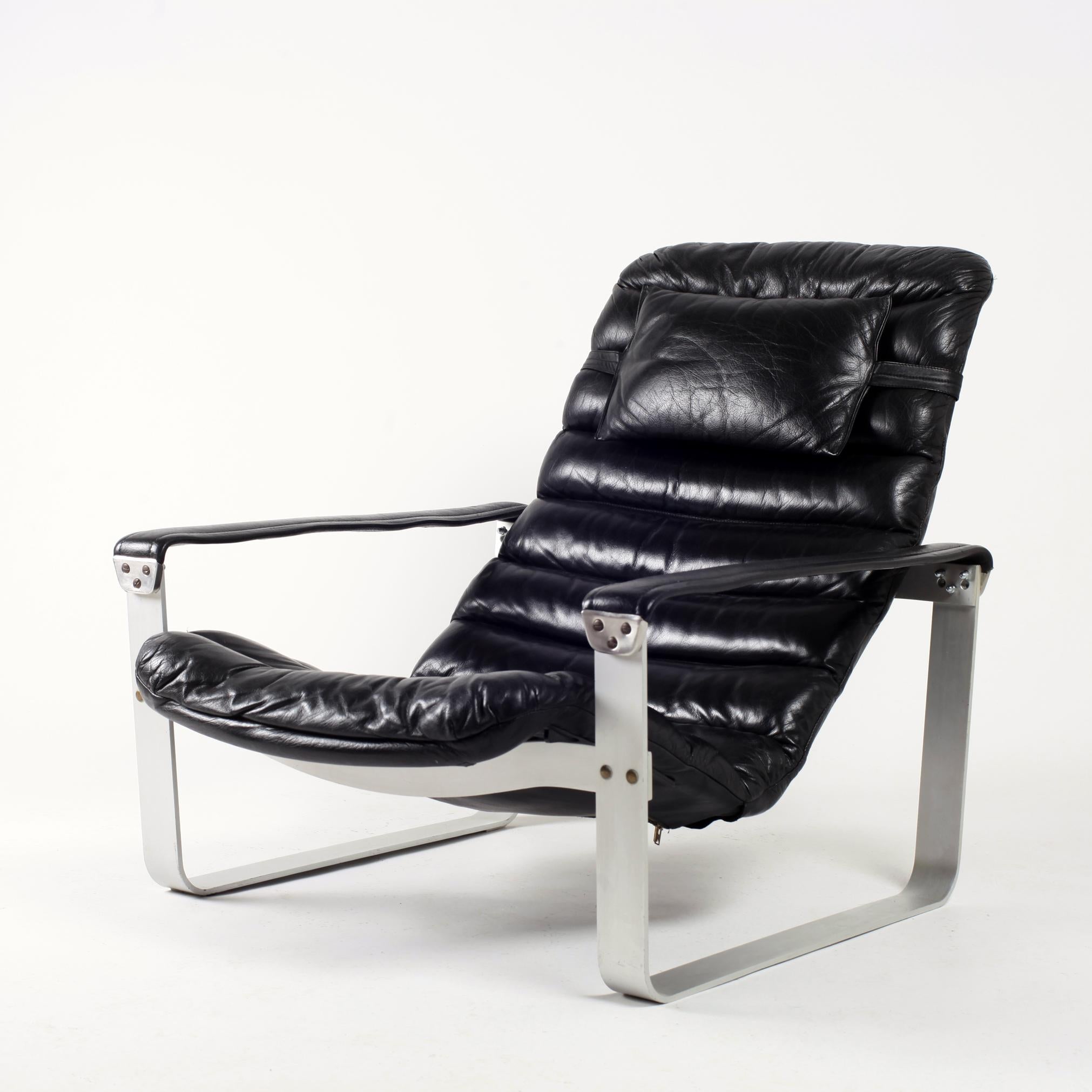 Pulkka lounge chair by Ilmari Lappalainen for Asko.
Aluminium frame with adjustable (three positions) black leather seat and armrest.
      